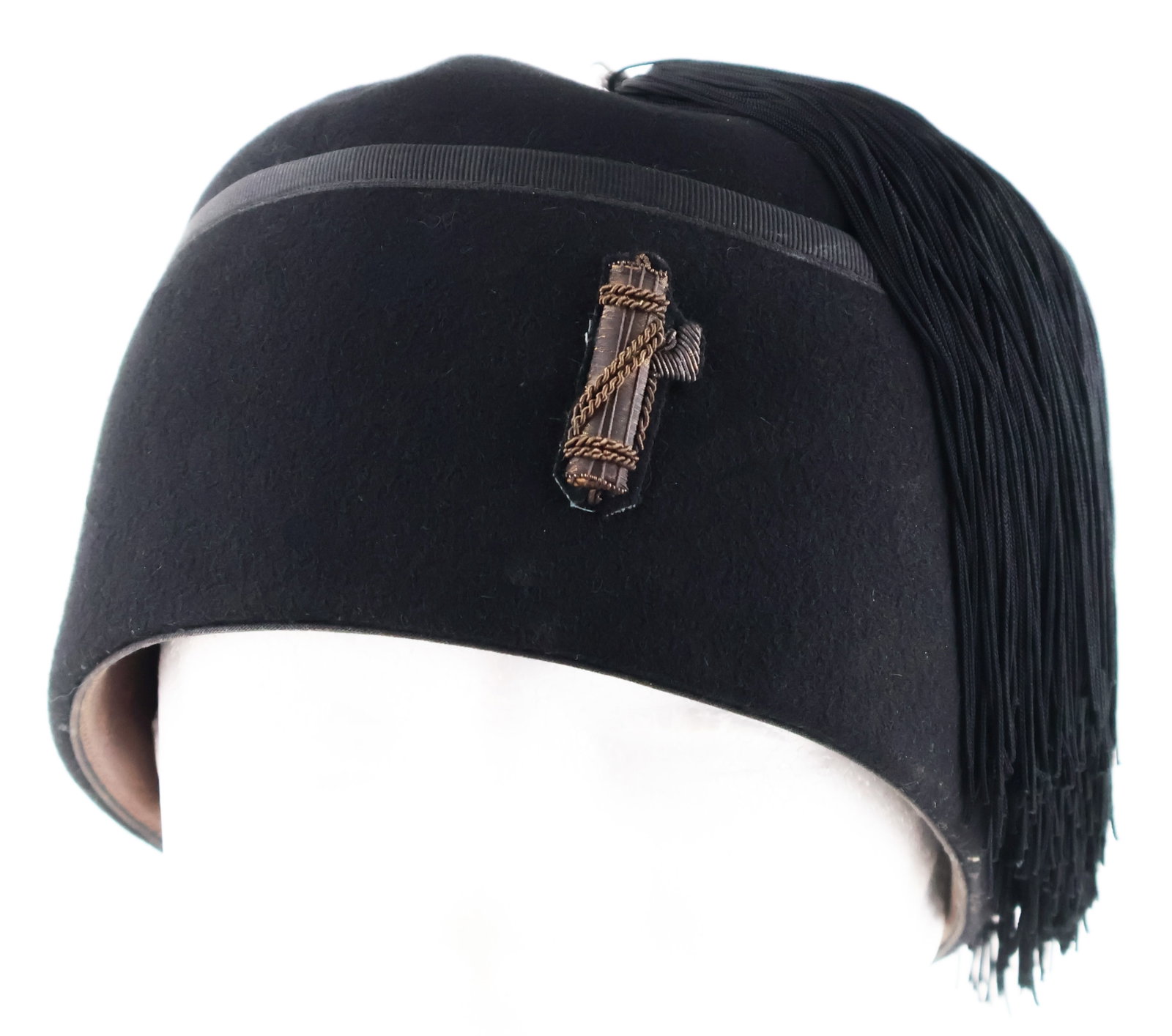 ITALIAN BLACKSHIRT FEZ: A well-preserved Italian Blackshirt fez constructed of black felt with a black sewn tassel which hangs over the right side. The front of the fez includes the symbol of the Italian Fascist party, thefa