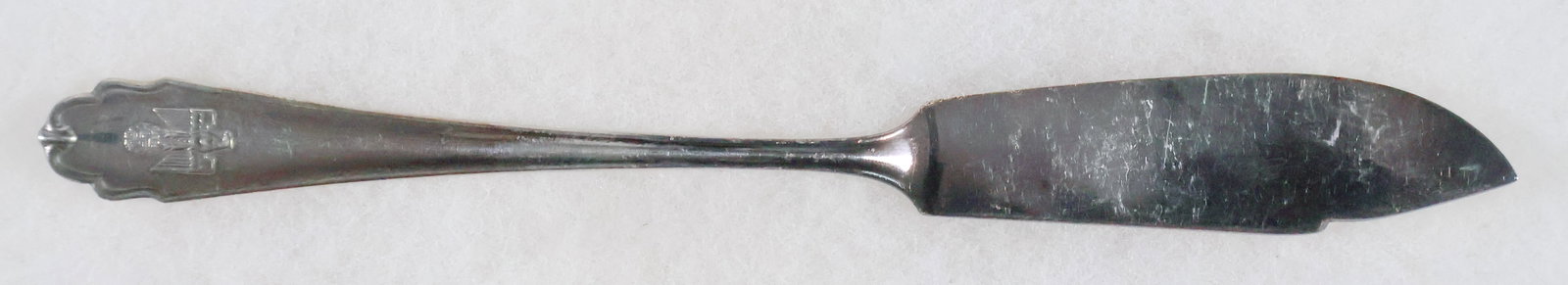 REICHS CHANCELLERY FISH KNIFE: A silver-plated fish knife spoon once used in the Reichs Chancellery in Berlin, 8 1/8 in. long with a fluted design, the bottom bearing a left-facing eagle clutching a static swastika in high relief. 