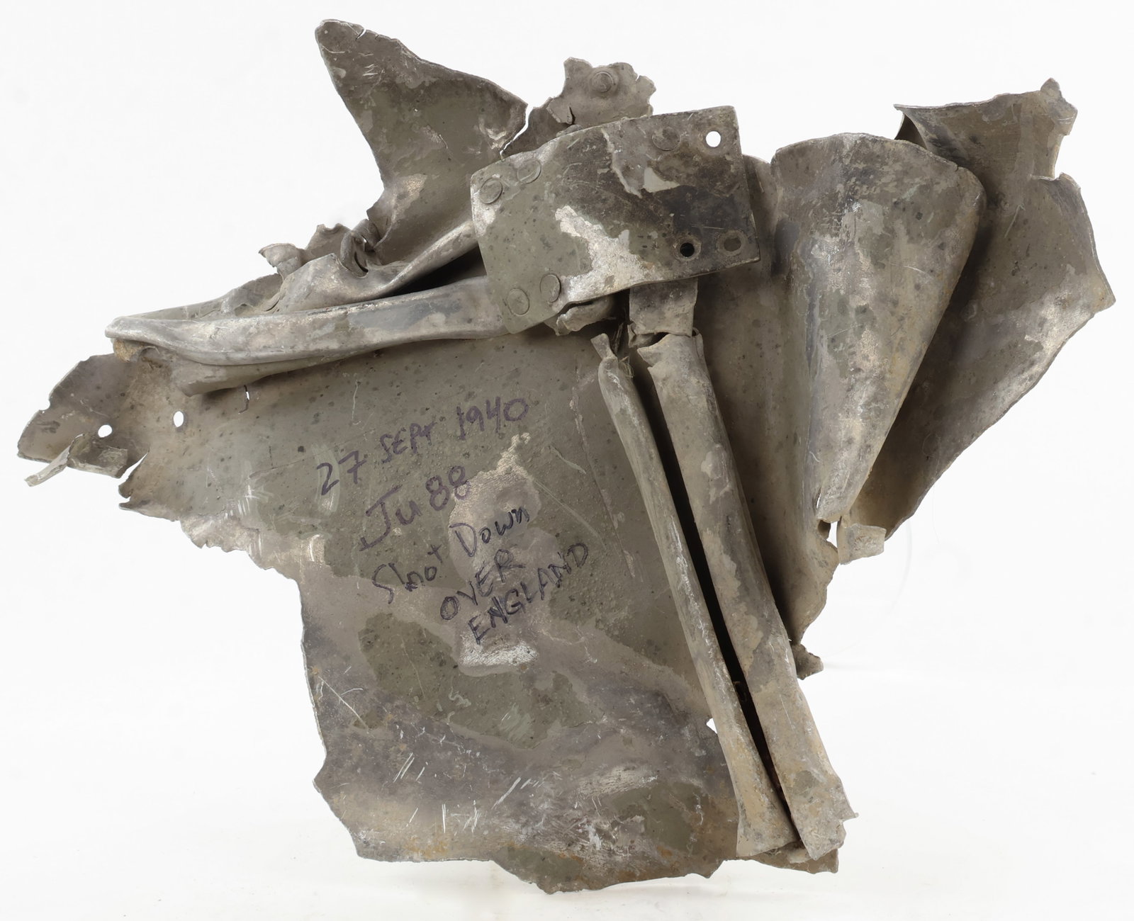 JU-88 CRASH RELIC FROM ENGLAND: Section of the fuselage of a crashed German Ju-88, a fast, twin-engine bomber. The 15 x 12 in. twisted piece of aluminum still bears green paint from the interior and exterior. A note penned post-1972