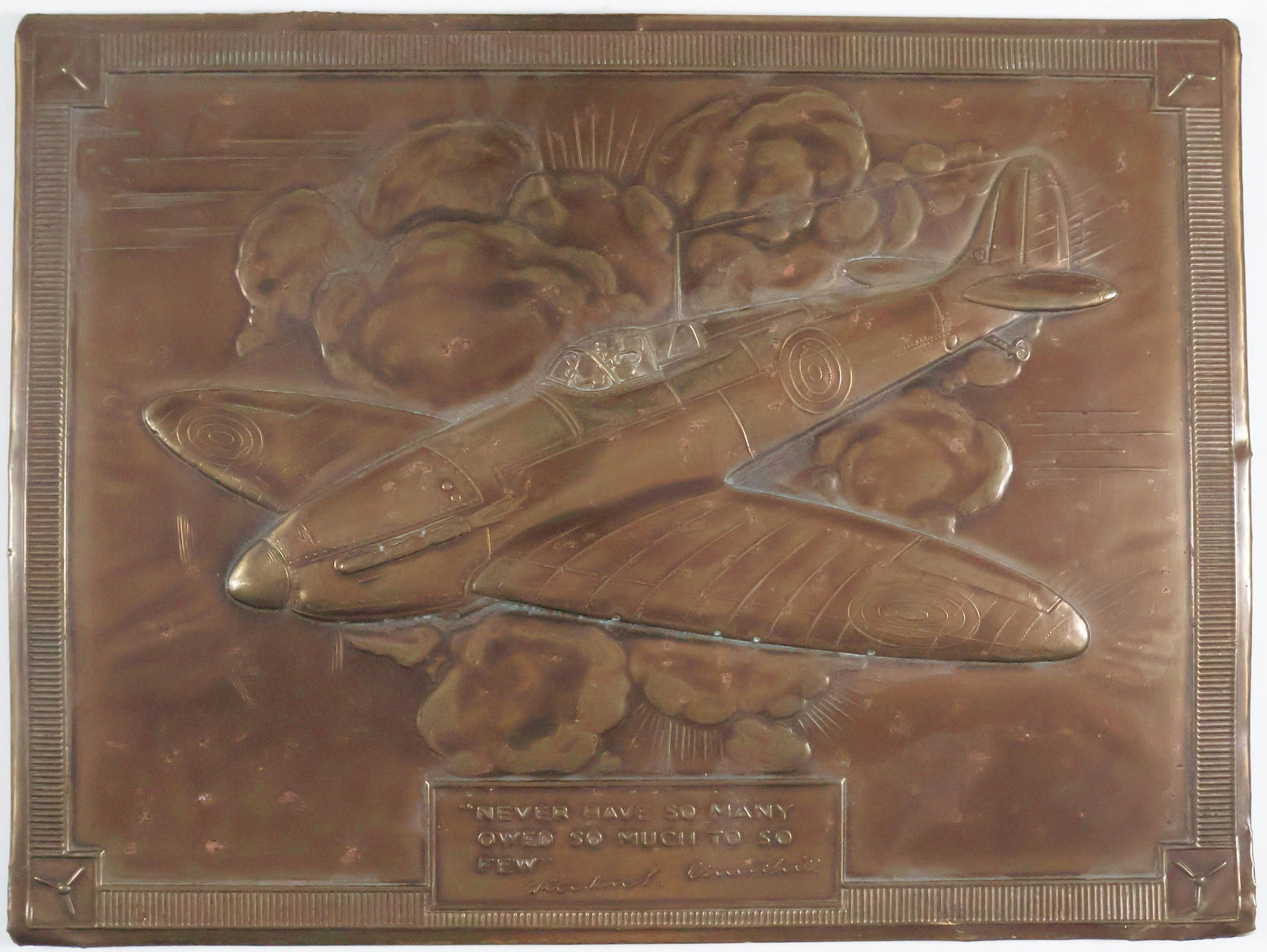 BATTLE OF BRITAIN COPPER PLAQUE: A period Battle of Britain souvenir, a mounted 12 x 9 in. copper sheet embossed with a Spitfire fighter in flight, bearing at the bottom Churchill's quote: 'Never have so many owed so much to so few'