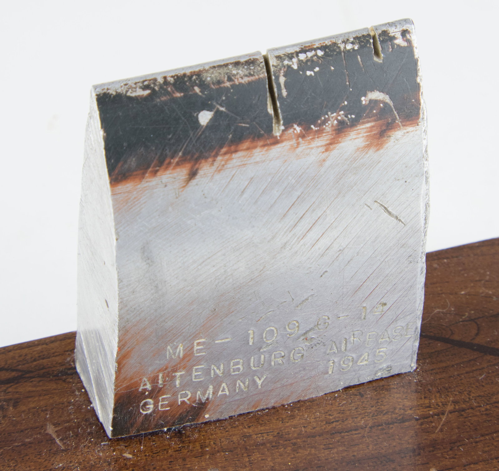 ME-109 PROPELLER RELIC: Small piece of a propeller, 2.25 x 2.5 in., taken from an Me-109 G-14 from World War II. The piece of propeller reads ‘ME-109 G-14 ALTENBURG AIRBASE GERMANY 1945’, with the reverse reading