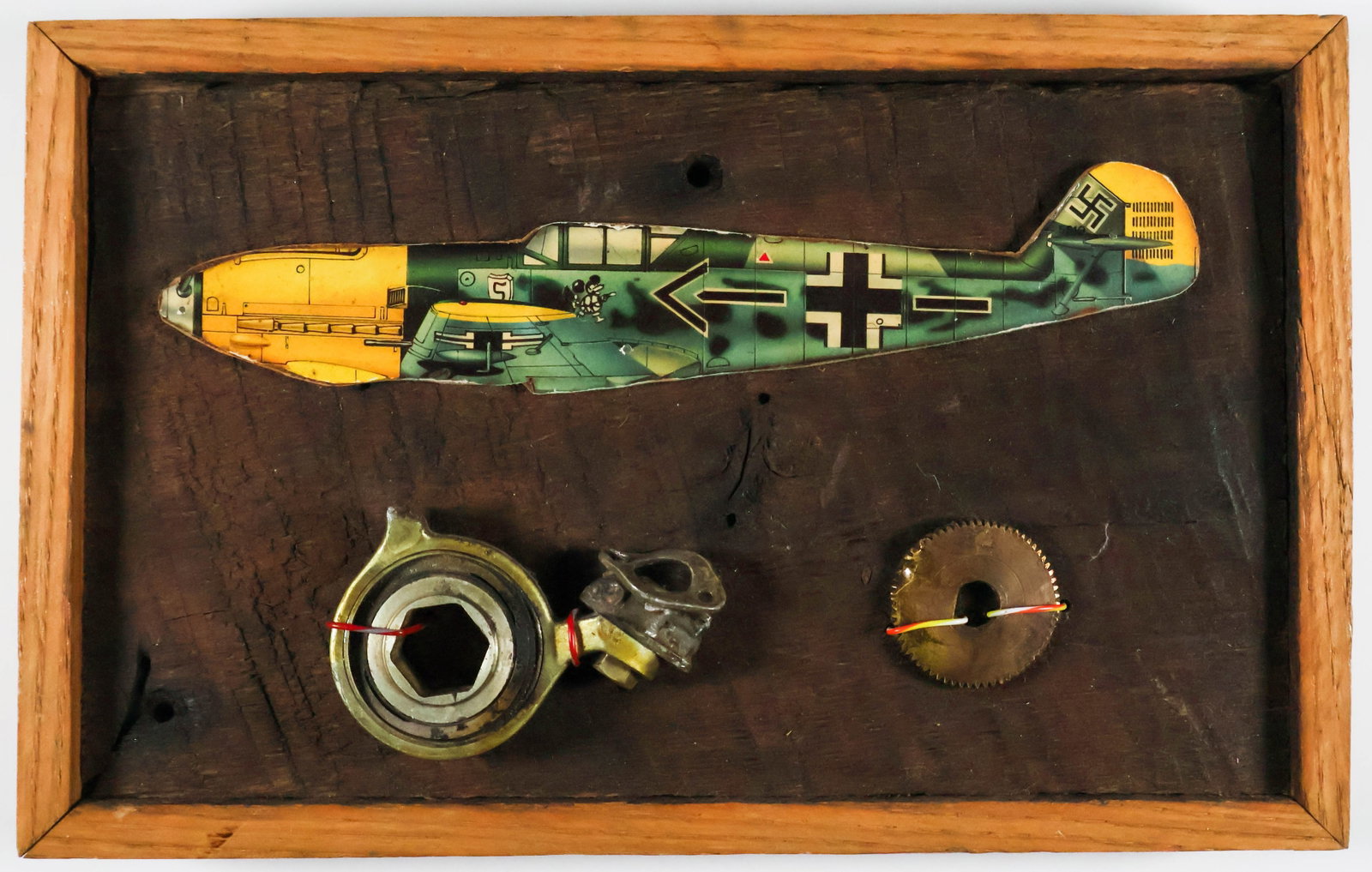 PIECES OF AN ME-109E SHOT DOWN OVER LONDON: A pair of small parts from an ME-109E that was shot down over London during the second month of the Blitz, Oct. 15, 1940. The pieces, which consist of a 1.25 in. gear and a small engine part, are atta