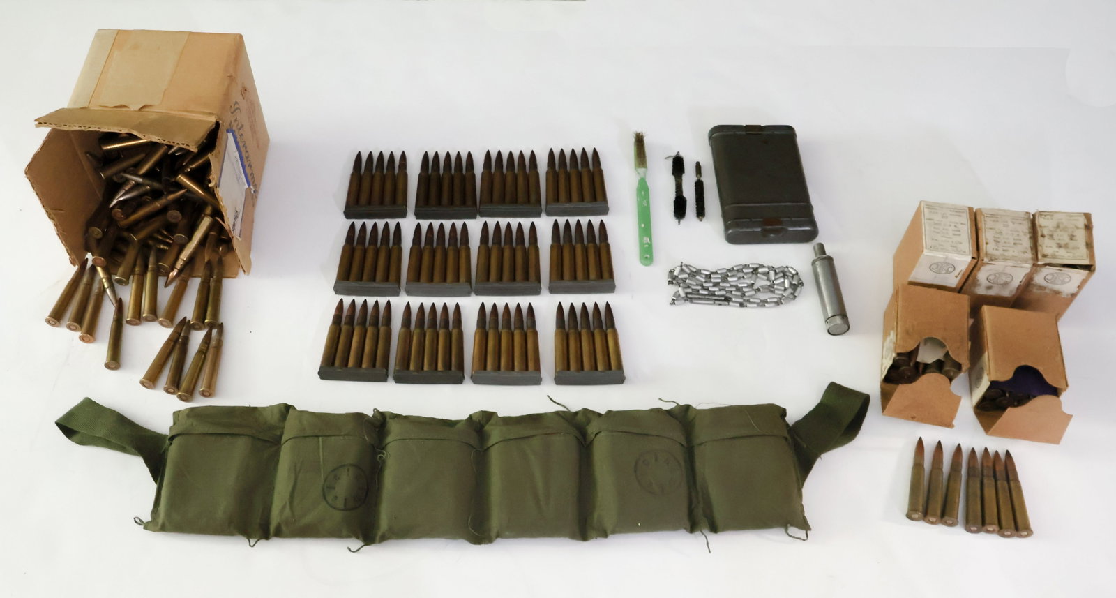 WORLD WAR II AMMUNITION AND ACCESSORIES: Loose selection of World War II ammunition of various origins, calibers, and dates. Including: (60 rounds) of .30-06 in 5-round stripper clips all presented in a disposable bandolier; (100 rounds) of 