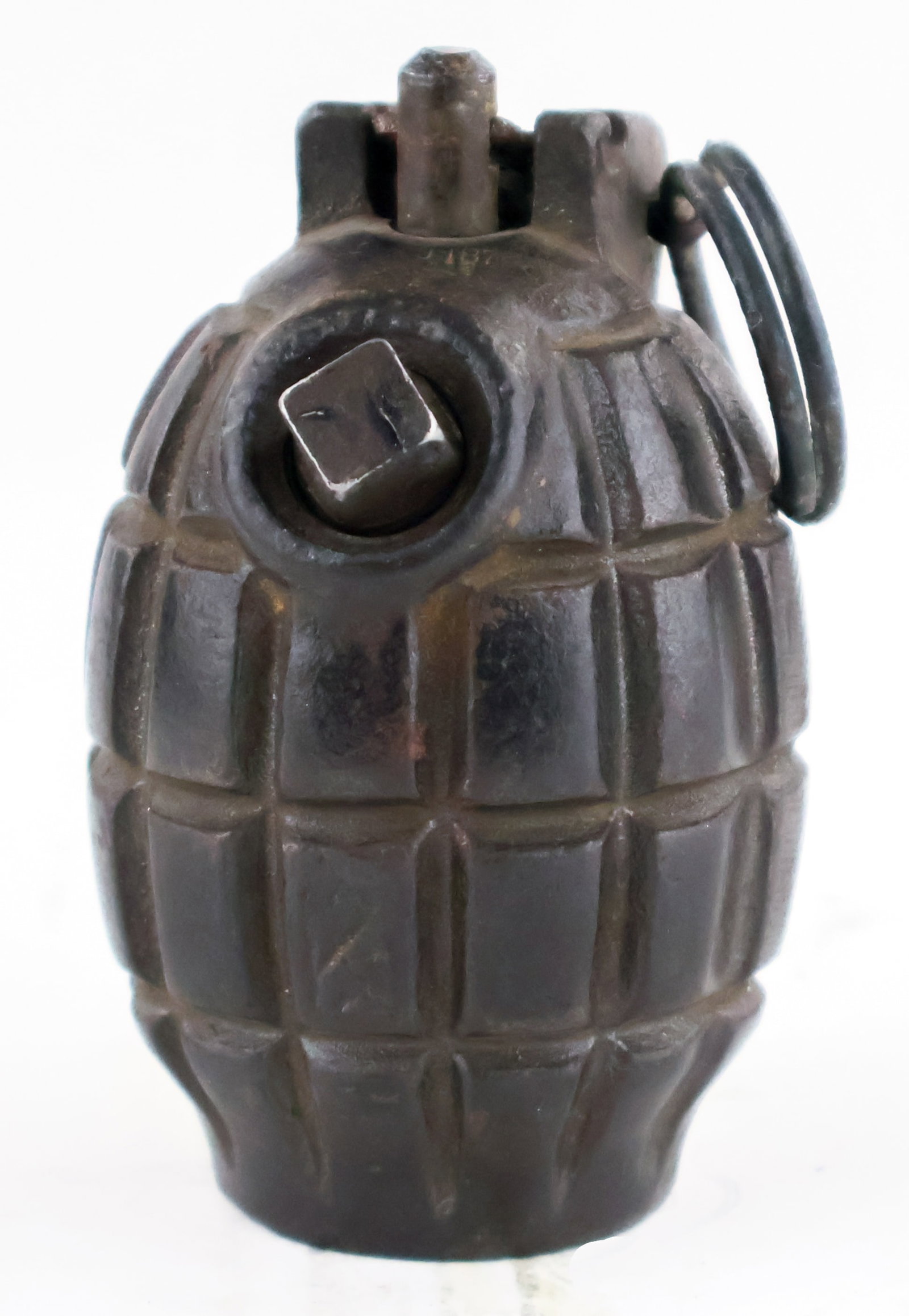 WORLD WAR I MILLS BOMB: The Mills was a classic design; a grooved cast iron 'pineapple' with a central striker held by a close hand lever and secured with a pin. Although the segmented body helps to create fragments when the