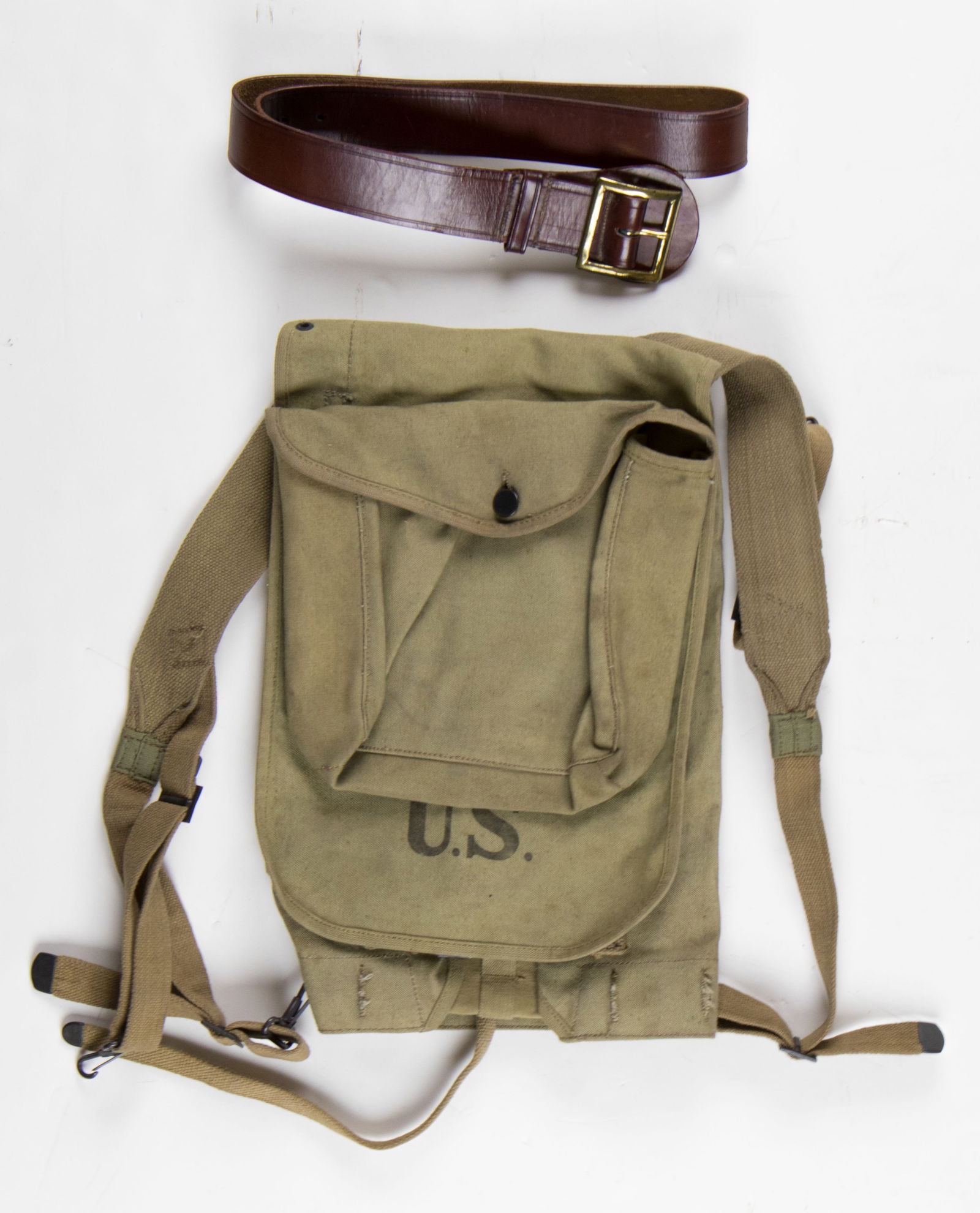 M1910 U.S. ARMY HAVERSACK: Original U.S. khaki M1910 haversack, unissued, with all straps and closures present, though tip of one strap nearly severed. Marked with maker's name 'Simmons' and dated 1917. SOLD WITH: a brown U.S.