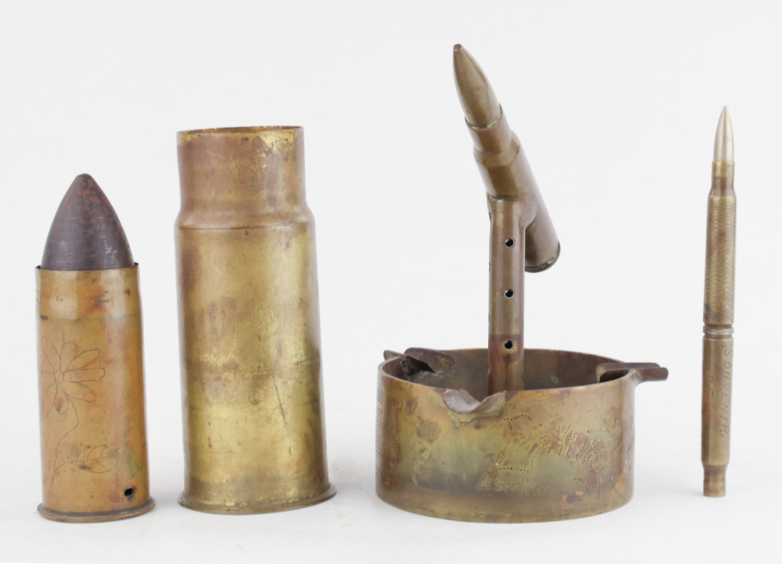 WORLD WAR I TRENCH ART (4): A fine collection of four pieces of trench art from World War I. Includes: an ashtray with a 20mm artillery shell as a centerpiece made by an enlisted man in the Army Corps of Engineers, an artillery 