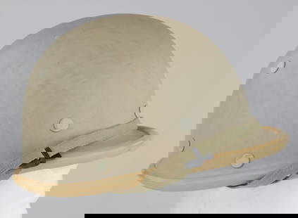 IRAQI M90 HELMET: A rare Iraqi M90 helmet made of plastic in a light tan paint scheme and wide plastic rim. The interior has the original chin strap and leather sweatband. Some damage to the liner, otherwise very good.