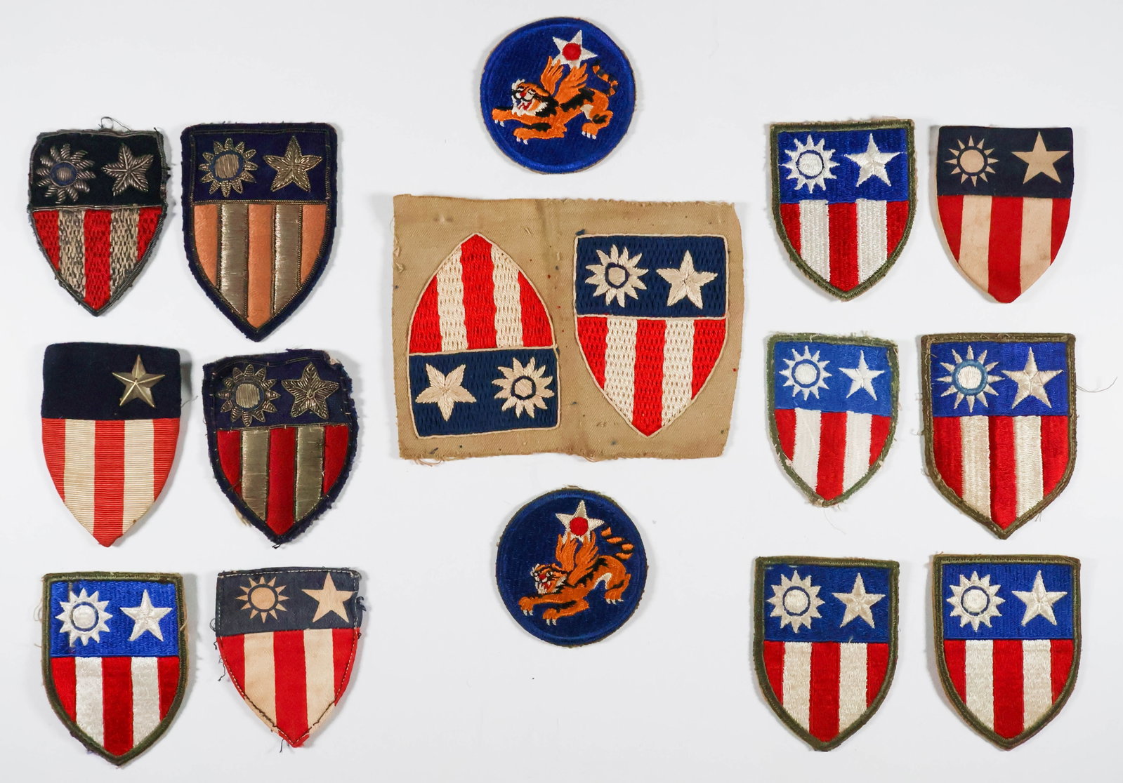 CHINA-BURMA-INDIA SHOULDER AND JACKET INSIGNIA (16): Sixteen varied pieces of chest and shoulder insignia issued to fliers, crewmen and soldiers in the China-Burma-India theater of war. Generally very good.