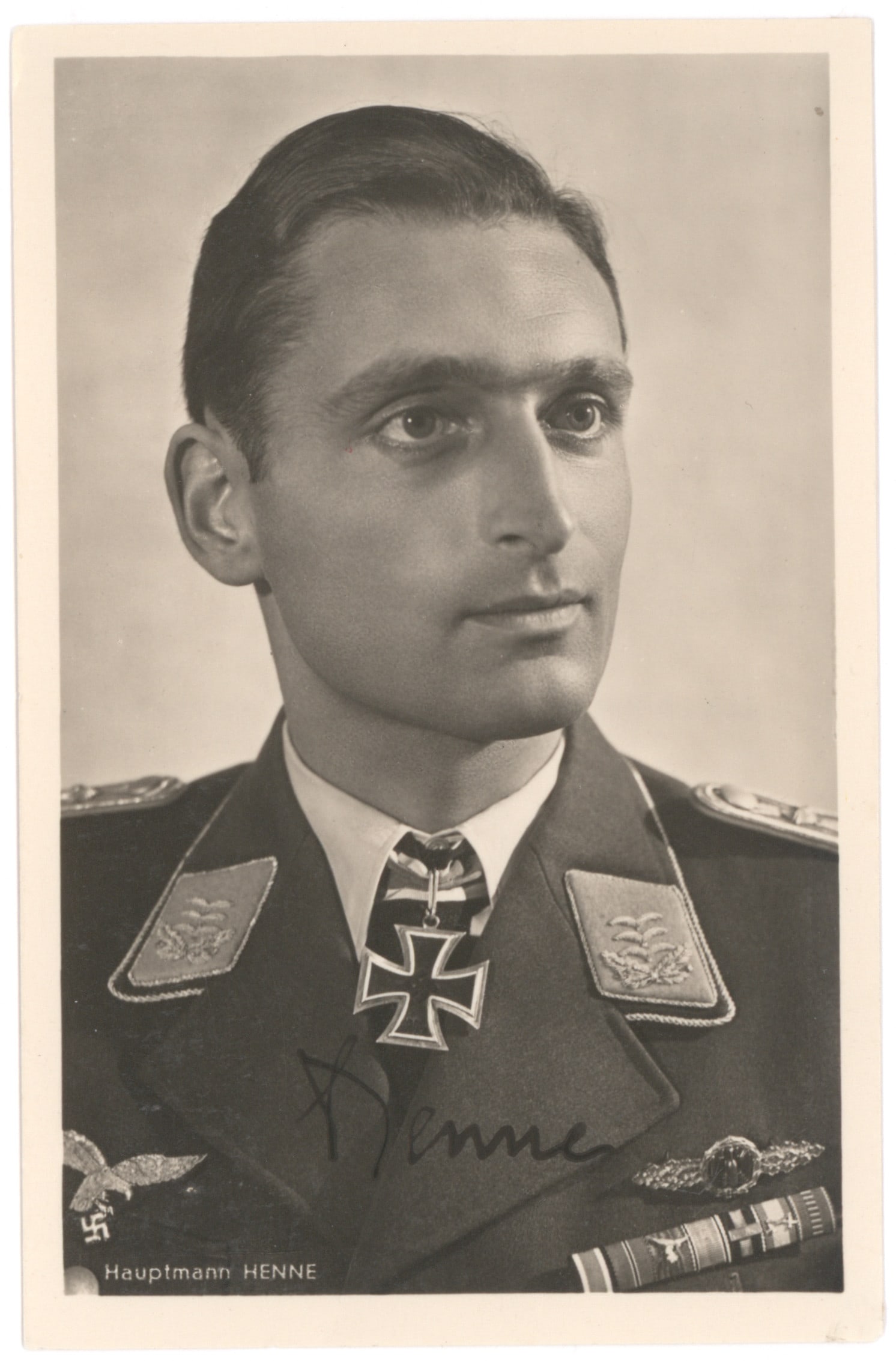 RUDOLF HENNE: (1913 -1962) Luftwaffe bomber pilot and recipient of the Knight's Cross. S.P. 4 x 6 in. sepia, a Hoffman real-photo postcard, boldly signed at bottom. Light mounting traces to corners on verso, else n