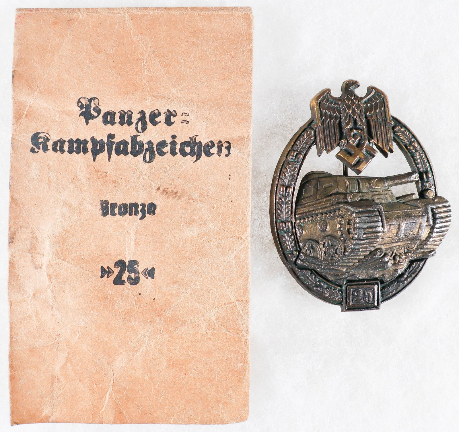 25 ENGAGEMENT PANZER ASSAULT BADGE IN BRONZE BY BREHMER: Very fine 25 Engagement Panzer Assault Badge in Bronze by Gustav Brehmer, made of two pieces of die-struck zinc. The outer oak leaf wreath bears a Reichsadler clutching a swastika at the top, and a de