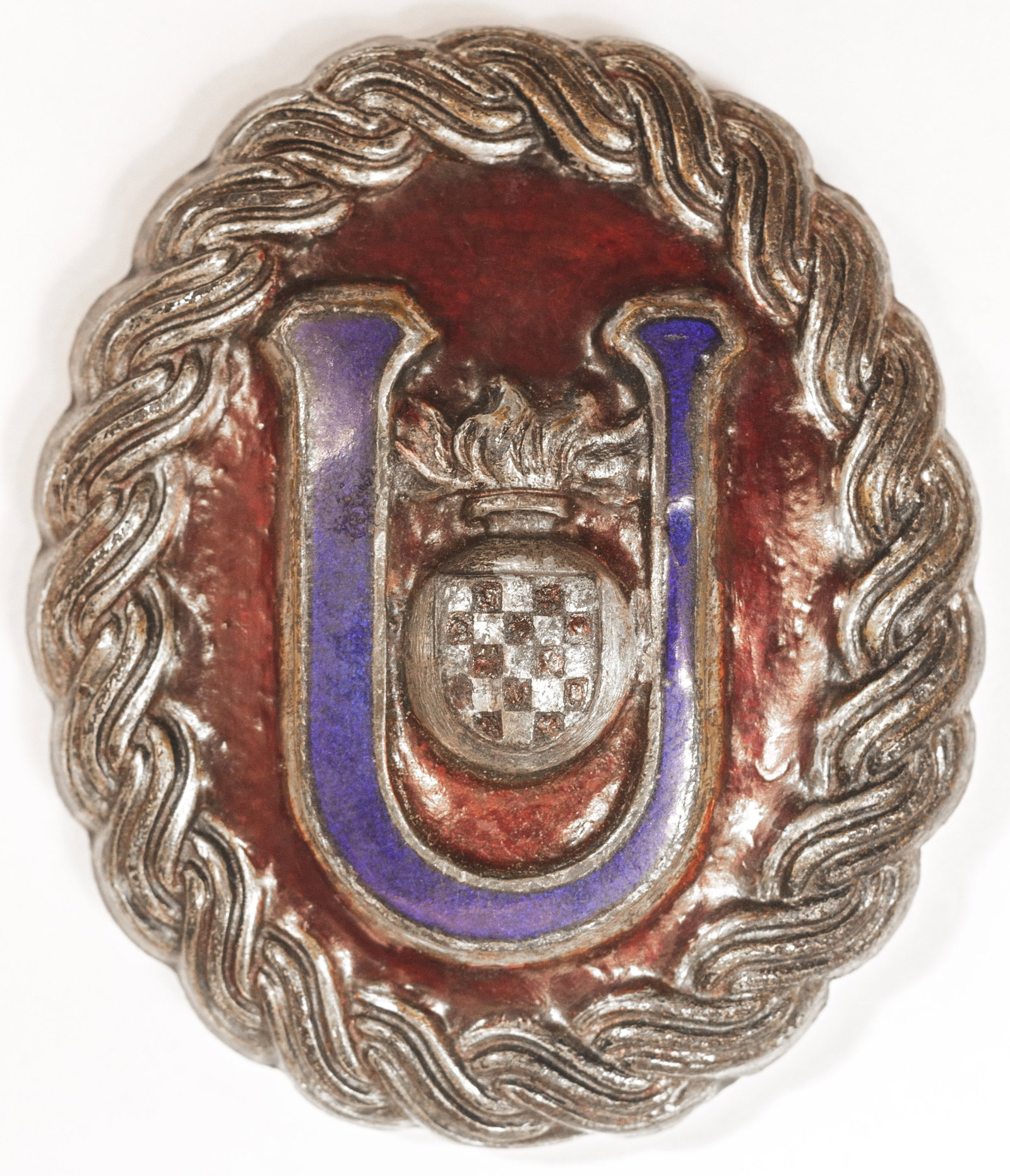 INDEPENDENT STATE OF CROATIA USTASE OFFICER’S BELT BUCKLE: Rare World War II-era belt buckle, 1.75 x 2.25 in., worn by officers of the Ustase, the ruling party of the Independent State of Croatia. The oval buckle is constructed of silvered tombac, die-stamped