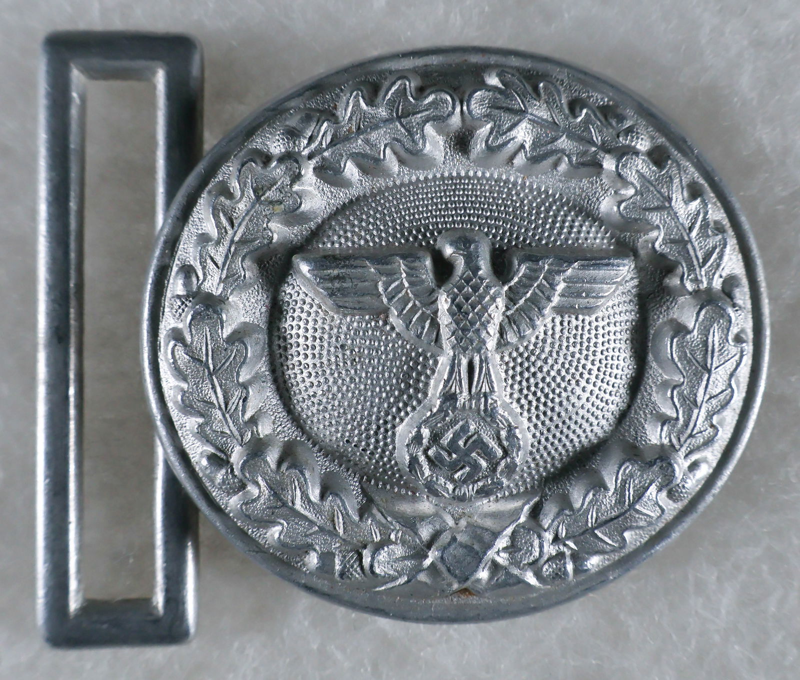 GERMAN STATE FORESTRY OFFICIAL'S BELT BUCKLE: Very fine German State Forestry Official's belt buckle, 2.25 in. wide aluminum two-piece construction, bears the Assmann hallmark on reverse. Excellent example.