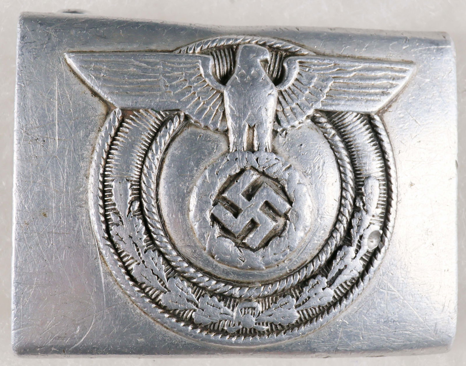 S.A. WEHRMANNSCHAFT BELT BUCKLE: Rare S.A. Wehrmannschaft belt buckle, aluminum, displaying a German national eagle and mobile with a ring or rays and oak leaves. The reverse has an integral, molded catch for the belt hook and functi
