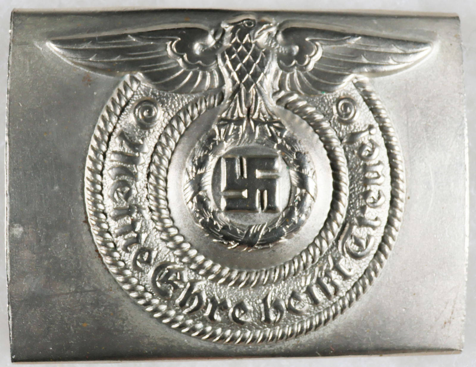 SS BELT BUCKLE IN STEEL: Uncommon SS belt buckle in steel, highly-detailed and in very fine condition, unmarked. The prongs on the reverse show obvious signs of long use, and the catch has been professionally replaced. A very