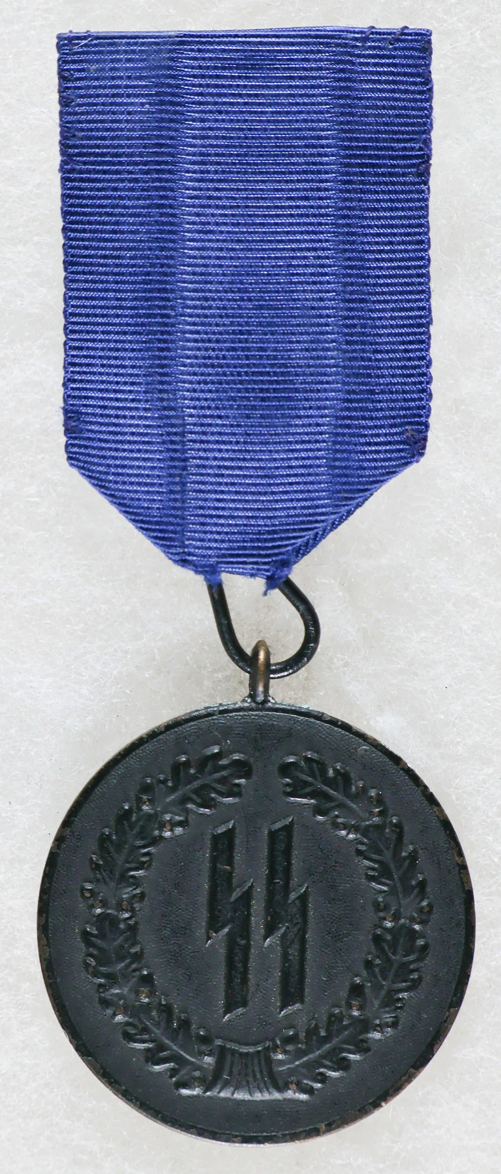 SS FOUR-YEAR SERVICE MEDAL: SS Four Year Service Medal, brass alloy (Tombak) construction with a blackened finish which remains entirely intact. All of the original detail is likewise excellent, save for a few spots of scattered