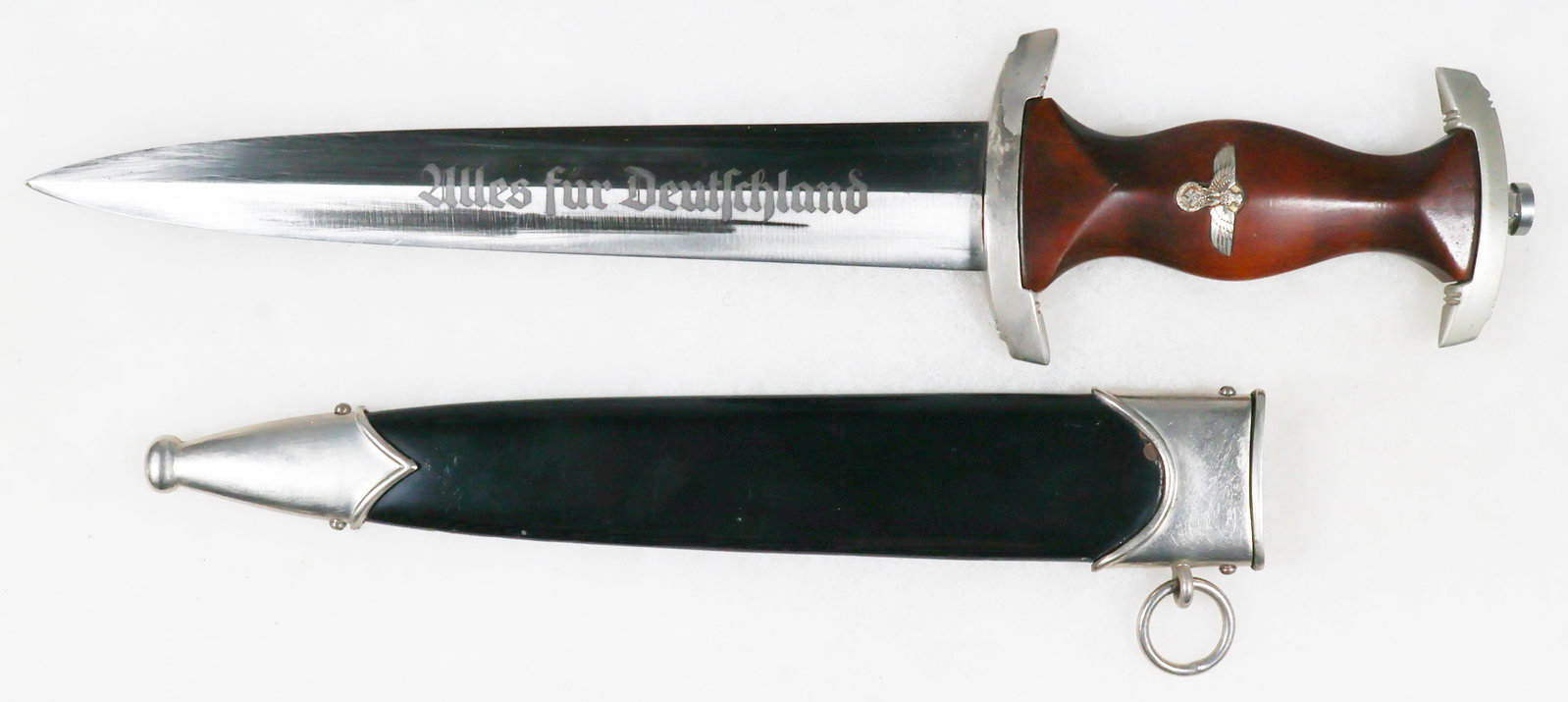NSKK DAGGER BY SCHUTTELHOFER: NSKK dagger, 8.5 in. blade, 13.5 in. overall, with brown hardwood handle and a painted black steel scabbard. The handle features a well-inset eagle and swastika, but no SA logo as is commonly seen. Wo