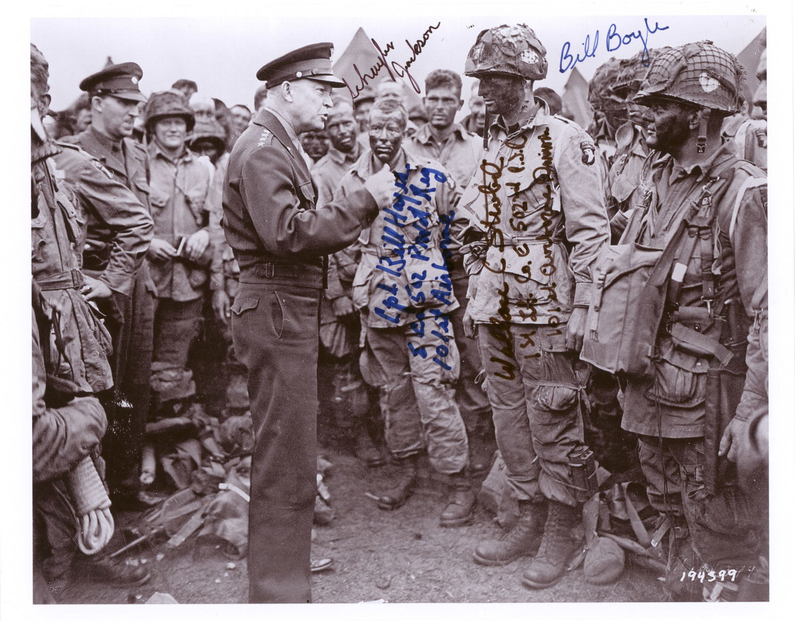 (D-DAY): Fine S.P. 11 x 8.5 in. b/w, a reprint of the iconic image of Eisenhower addressing troops just prior to the D-Day invasion and signed by four members of the 101ST Airborne Division: WALLACE C.