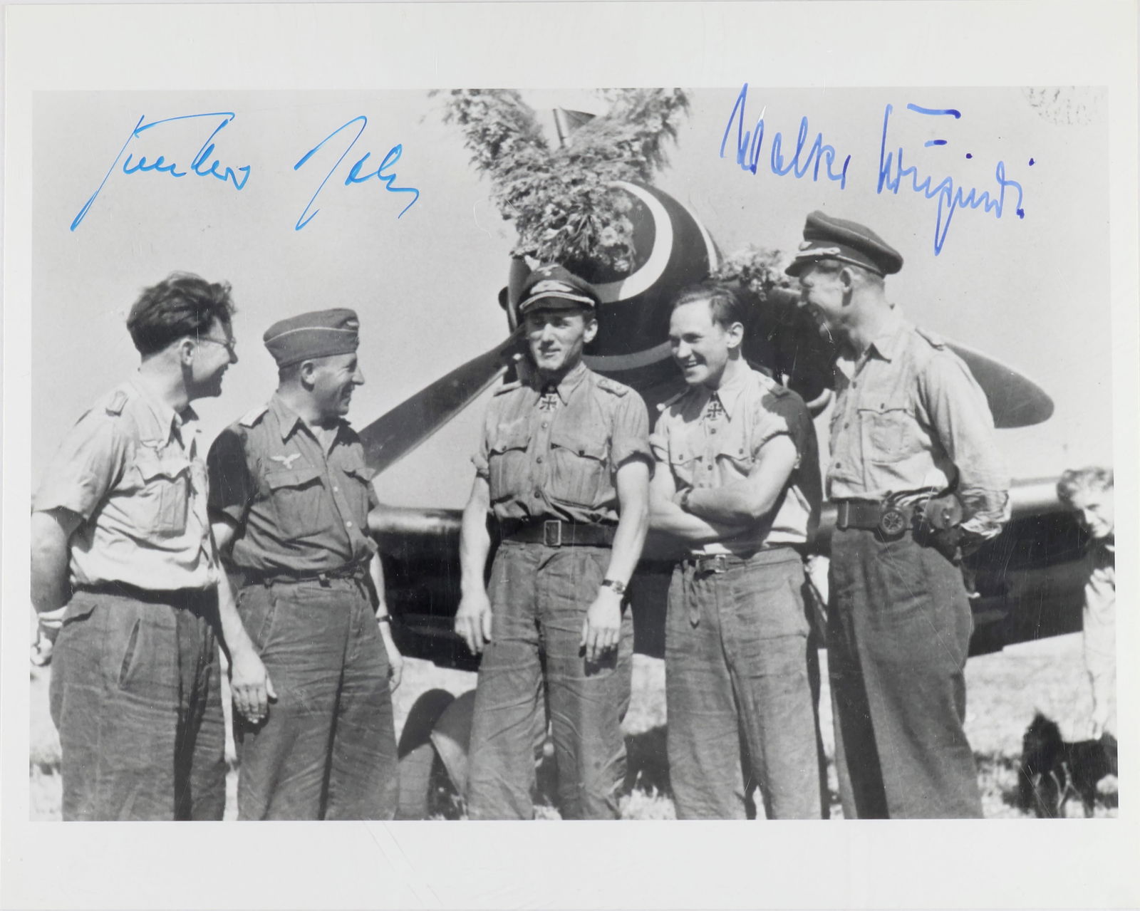 GUNTHER RALL AND WALTER KRUPINSKI: Signed photograph, 8 x 10 in. b/w, depicting four Luftwaffe members standing before a plane, including GUNTHER RALL (1918 - 2009) German fighter pilot and third highest ace with 275 'kills', and