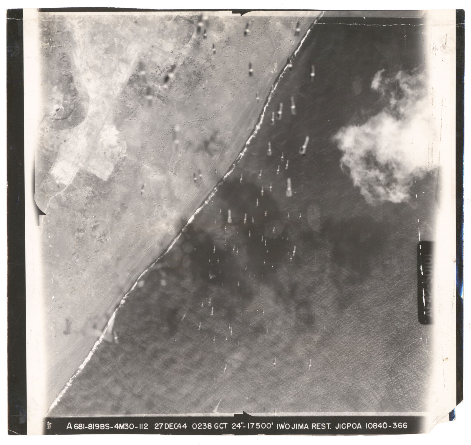 PRE-INVASION AERIAL PHOTOGRAPHS OF BEACHES AND BOMBARDMENT OF IWO JIMA (4): Fine lot of four original Army Air Force aerial photographs all taken just prior to the American invasion of Iwo Jima, three images showing after effects of bombardments of Japanese fortifications on