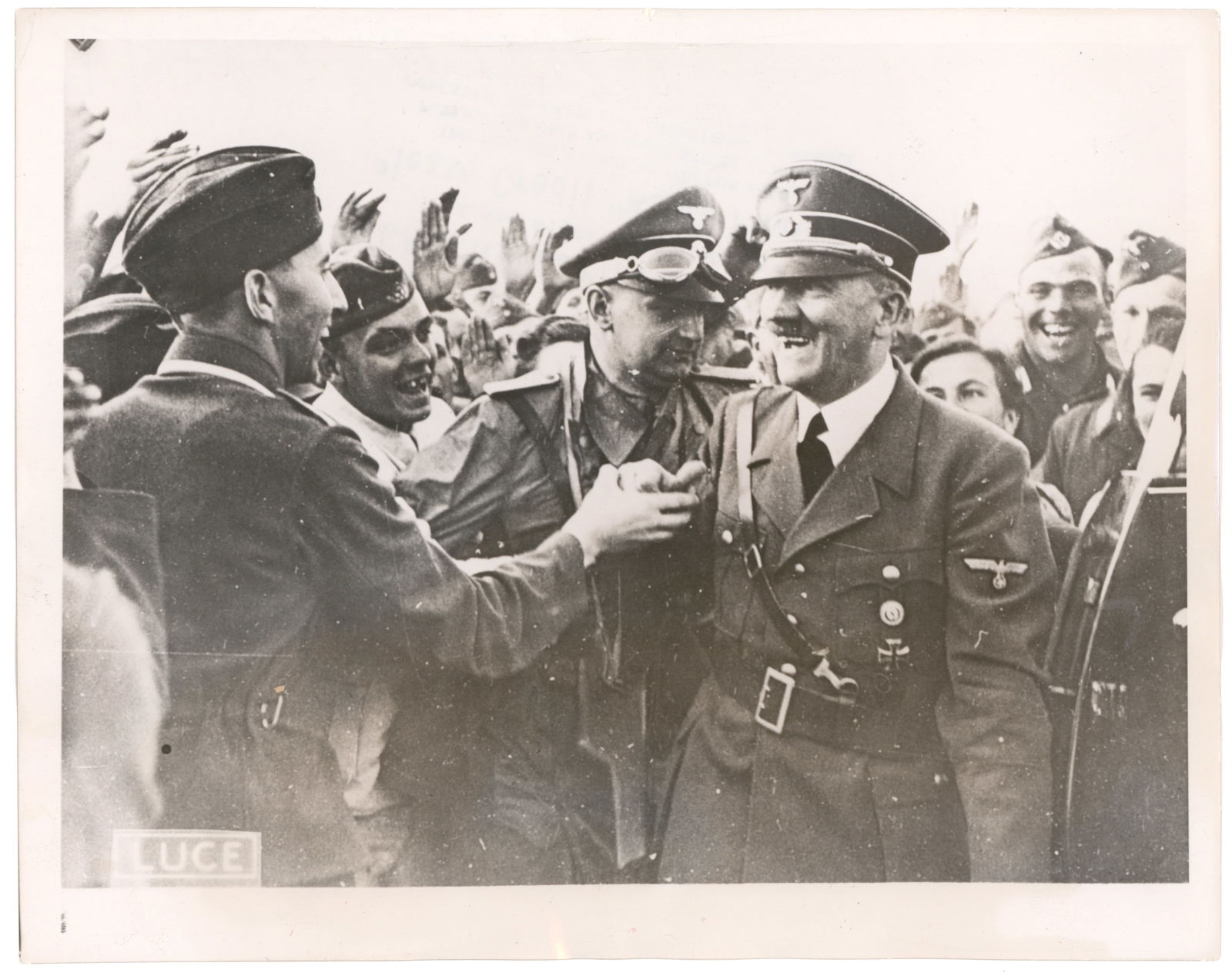 ADOLF HITLER PRESS PHOTOS (5): A fine group of five press photographs about 7 x 9 in. each and depicting Hitler a variety of scenes. Each is backstamped, and many have press blurbs as well. Includes: Hitler at the 1936 Olympics, on