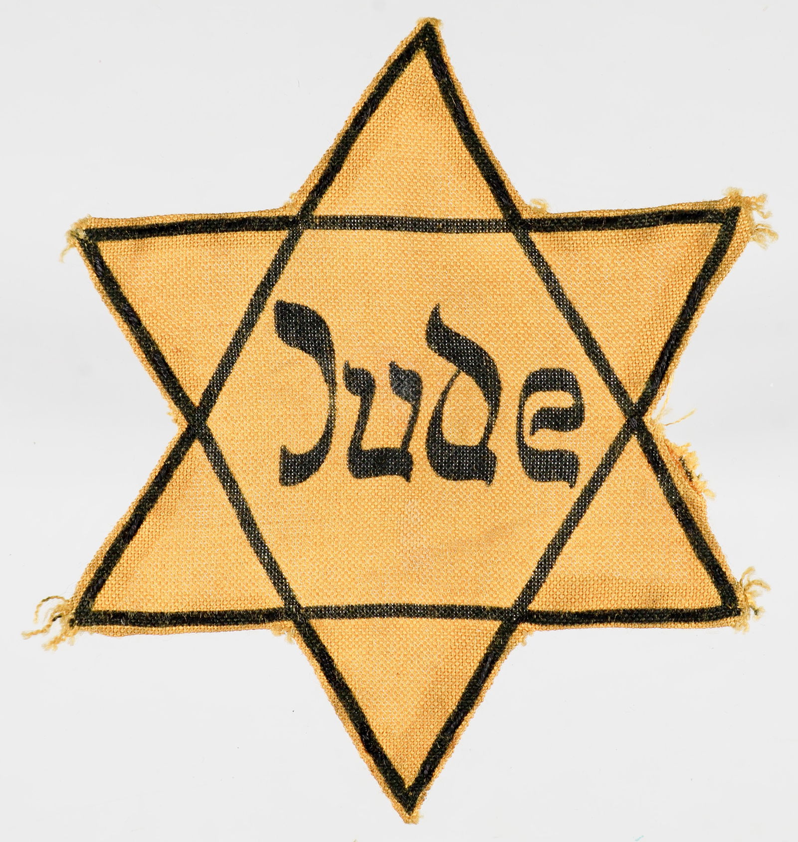 GERMAN 'JUDE' CLOTH STAR OF DAVID: A garment-removed yellow cloth Star of David imprinted 'Jude', 3.85 in. diameter, in correct yellow cloth color and weave, very heavily printed in black. The reverse shows the rough-cut trimmed edges