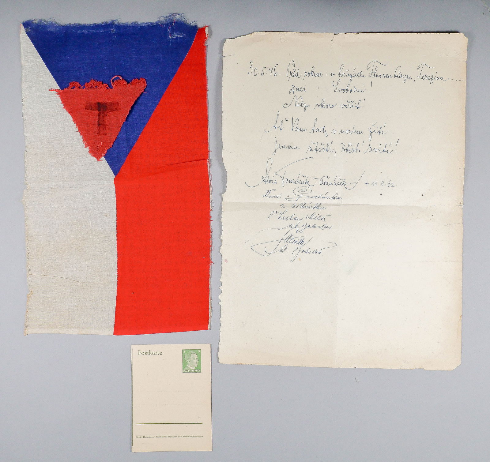 CZECH PRISONER'S CLOTH TRIANGLE, CELEBRATORY DECLARATION, AND FLAG: An excellent grouping of identified Holocaust material, all associated with the imprisonment of Flossenburg prisoner, Czech national Karel Prochazka (b. 1893), a bank director from Mistek. Included