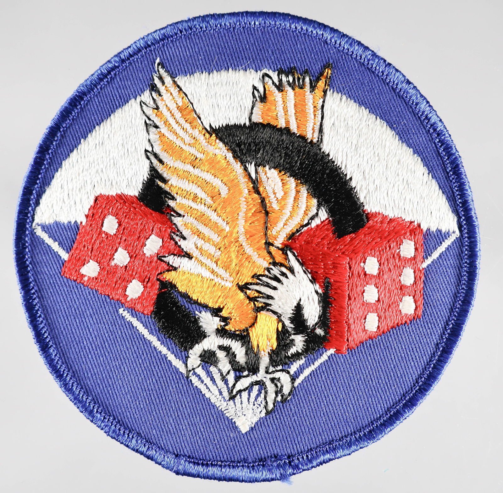 506TH P.I.R. JACKET PATCH: Rare wartime production 506th Parachute Infantry Regiment embroidered chest patch, 3 7/8 in. dia., displays a silver parachute in the background with a diving eagle at center. A black 'O' encircles th