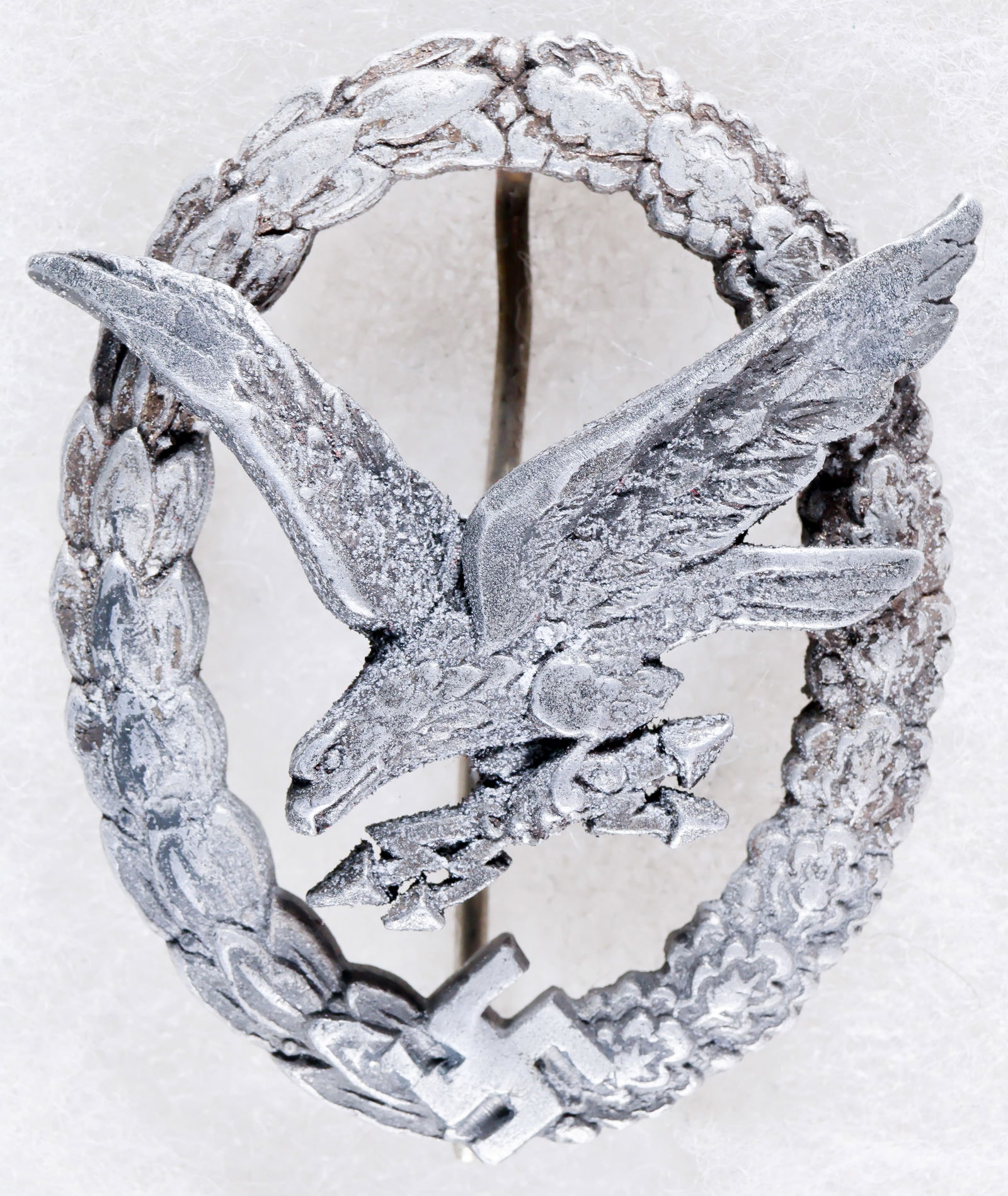 GERMAN RADIO OPERATOR & AIR GUNNER BADGE, IN ALUMINUM: Scarce German Radio Operator & Air Gunner Badge in aluminum, worn a bit, especially so at the eagle's wing tips and upper part of its leg as if the badge had been rubbed along a very rough surface (pa