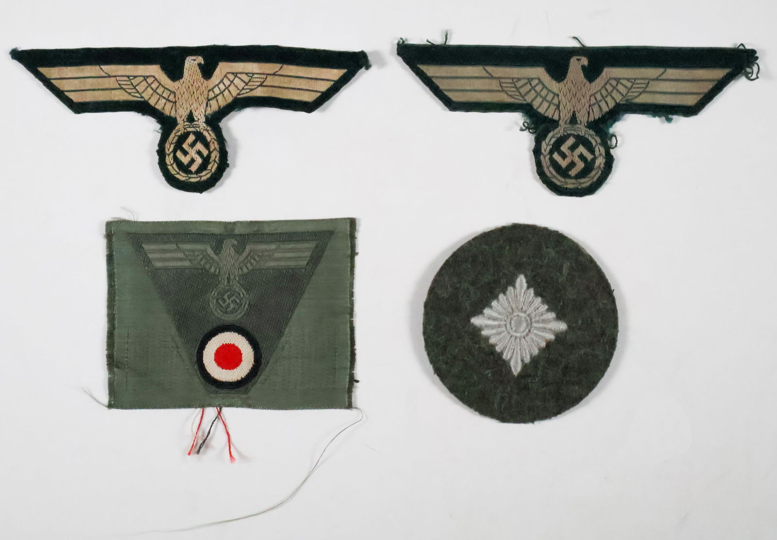 HEER UNIFORM INSIGNIA (4): Lot of four pieces of Heer uniform insignia, includes two chest eagles (one uniform-removed), and two qualification badge. Very good.