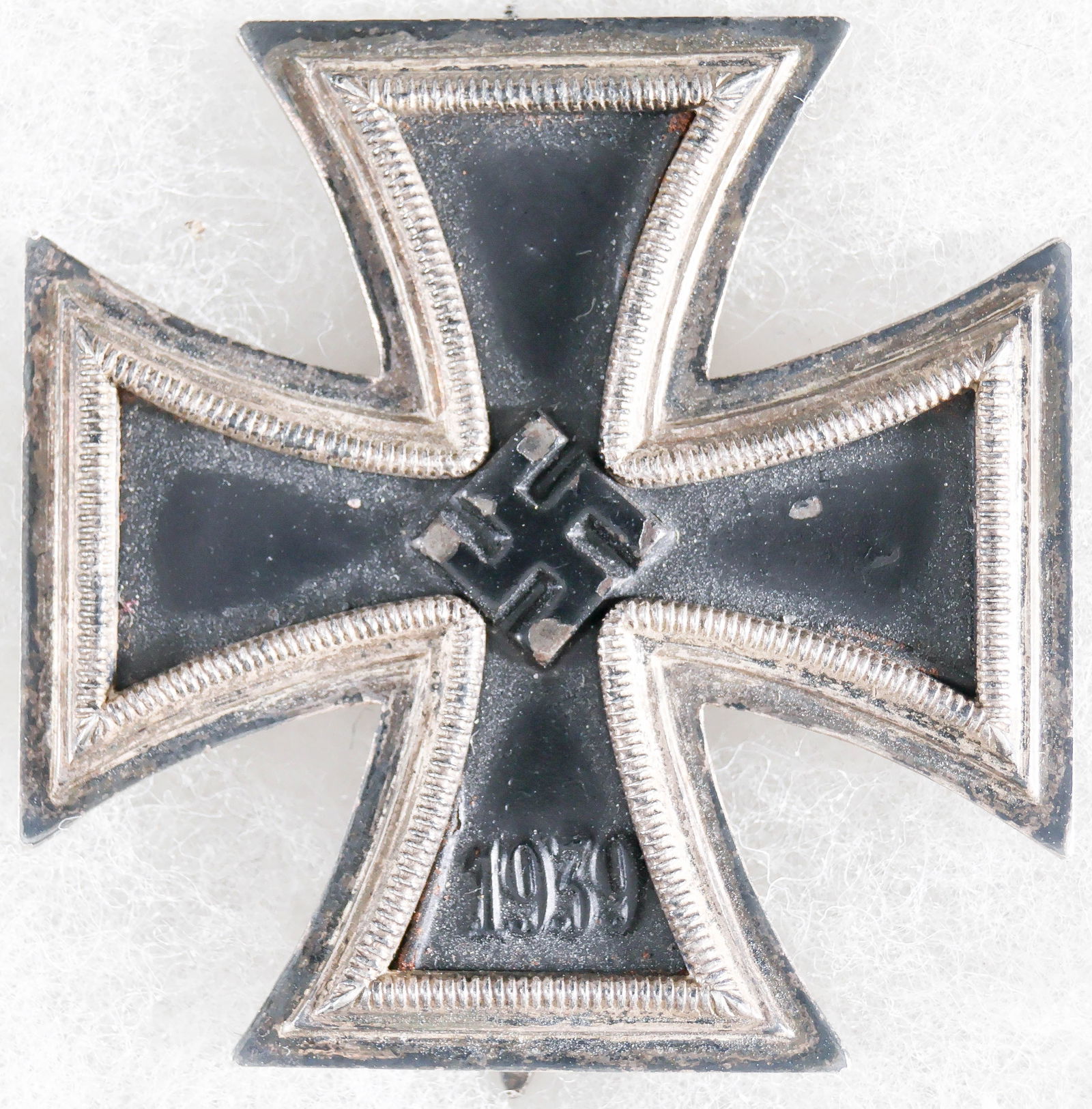 IRON CROSS FIRST CLASS: 1939 Iron Cross First Class. nickel silver frame with a magnetic iron core. Minor paint chips to finish of background, a few to swastika at center, coke bottle type pin with barrel hinge and flat