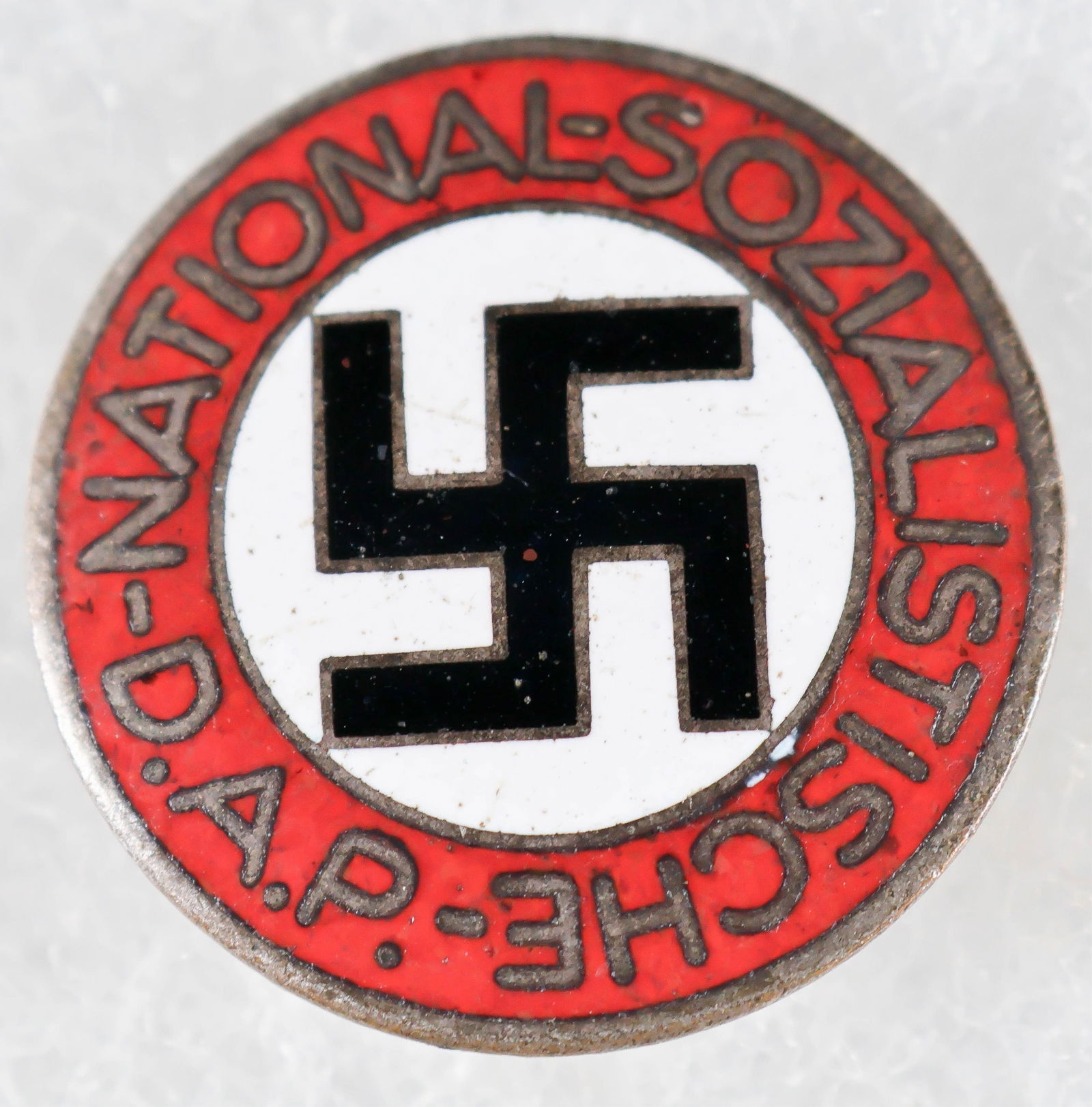 NSDAP BUTTONHOLE PIN: NSDAP enameled buttonhole party pin by RZM M1/14 Matth. Oeschsler & Sohn. Slightly worn on the face, else very good.