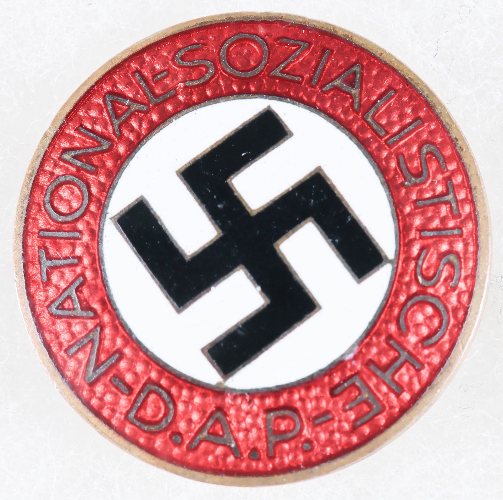 NSDAP PARTY PIN: An orginal NSDAP Party Pin constructed in red, white, black, and gold enamel. The reverse of the pin has the RZM maker's mark number ‘M1/92’ for manufacture Karl Wild of Hamburg, complete