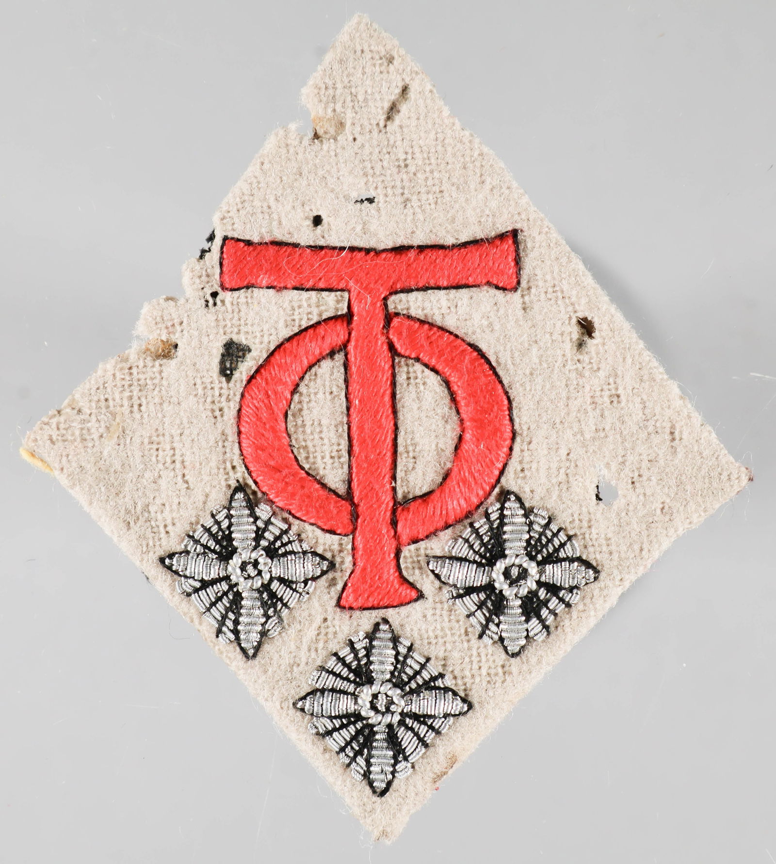 ORGANIZATION TODT LEADER'S COLLAR TAB: Orgaization Todt leader's collar tab, 2 x 2 1/8 in., off-white cloth with embroidered 'O T' and three silver officer's pips. A bit moth-eaten, still presentable.