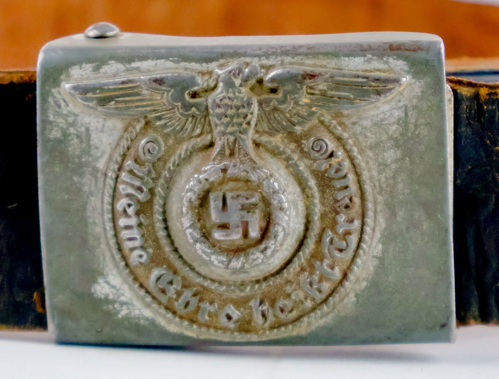 WAFFEN-SS BELT BUCKLE WITH BELT: German Waffen-SS enlisted man's belt buckle with leather belt, the buckle constructed of stamped steel with a silver-grey field finish. The obverse features the iconic embossed SS runes within a