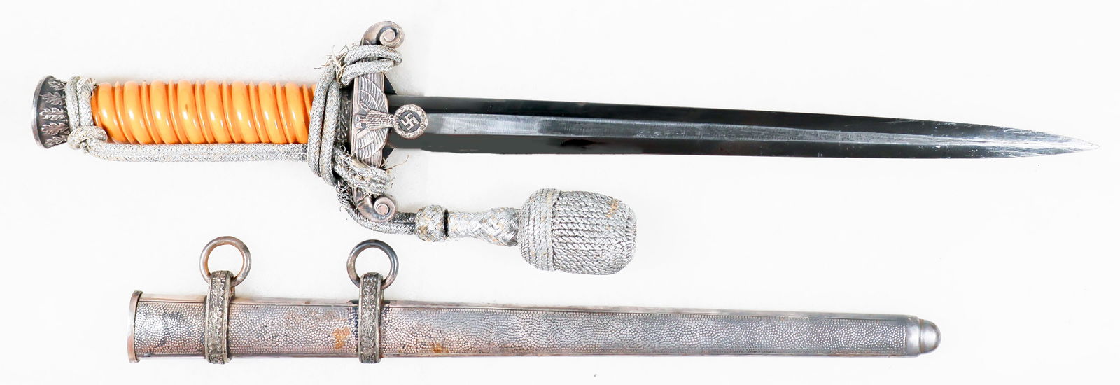 HEER OFFICER’S DAGGER BY CARL EICKHORN, WITH PORTAPEE: Third Reich Heer officer's dagger, 10 in. blade, 14.5 in. overall, with an orange celluloid grip secured to the tang by a circular steel pommel encircled with an oak leaf motif. The crossguard