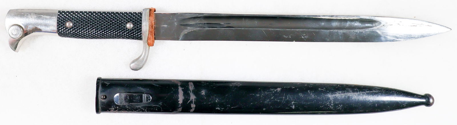 WEHRMACHT LONG DRESS BAYONET BY CARL EICKHORN: Good example of a Wehrmacht dress bayonet, 9.5 in. blade, 14.5in. overall, with chromed birdshead-style pommel and crossguard with a single quillon, with a brown leather buffer above. The pommel is fi