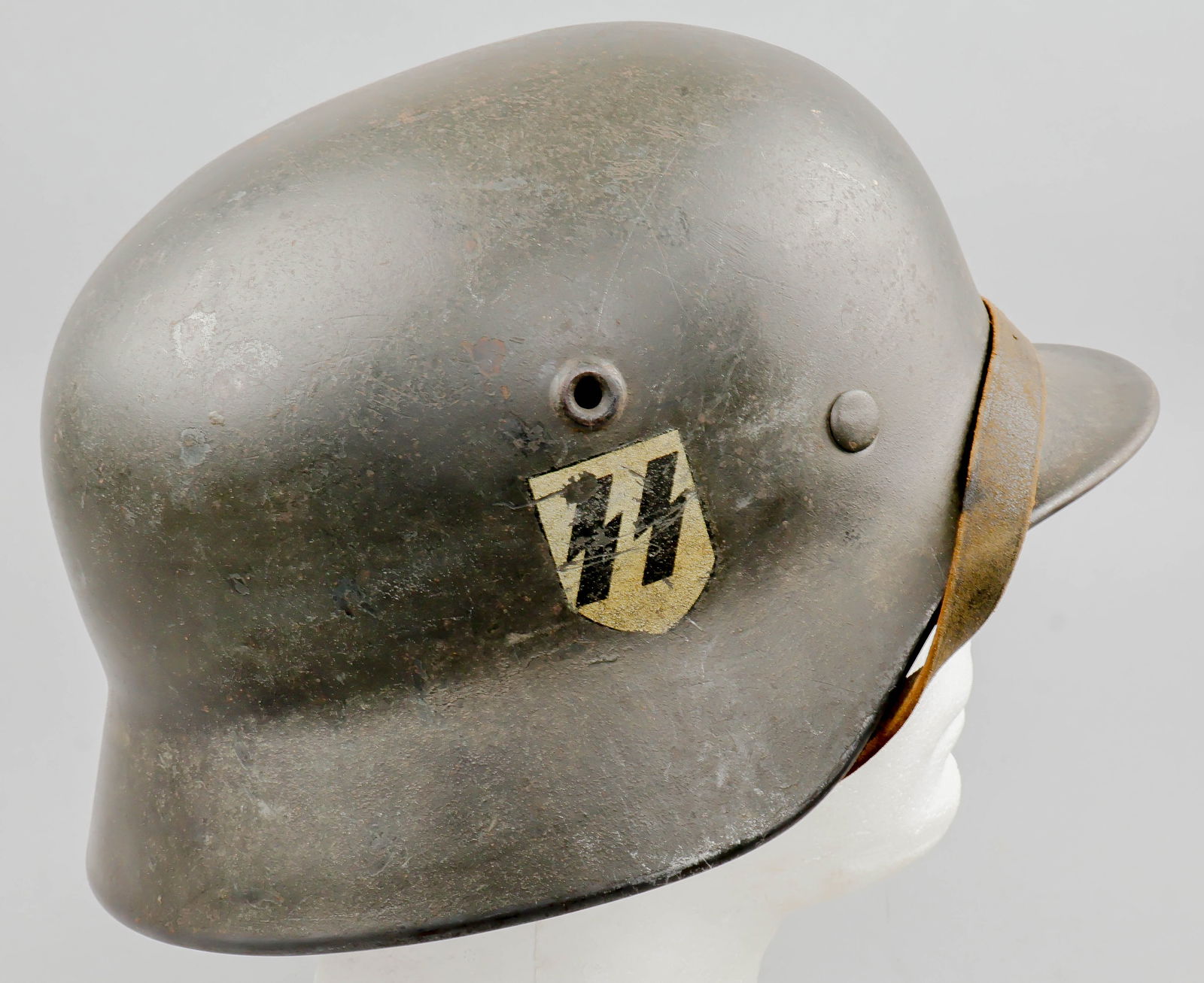 WAFFEN SS M40 COMBAT HELMET WITH CAMOUFLAGE COVER: A textbook example of a single-decal Waffen-SS M40 combat helmet, with appropriate field-gray finish inside and out. The right-hand side of the helmet displays a yellow-hued Quist SS runes decal. The