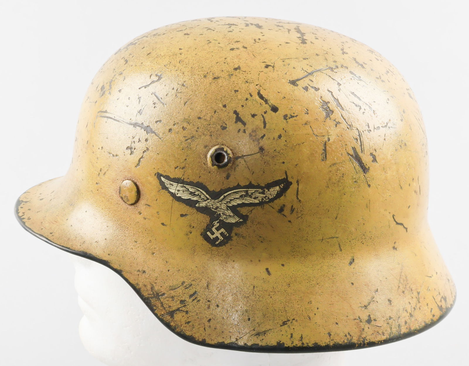 LUFTWAFFE DAK CAMOUFLAGE DOUBLE-DECAL M35 HELMET: A fine example of a German M35 combat helmet, featuring a Peiniger Luftwaffe eagle decal on the left-hand side, with a national tricolor decal on the right. The exterior of the shell is painted overal
