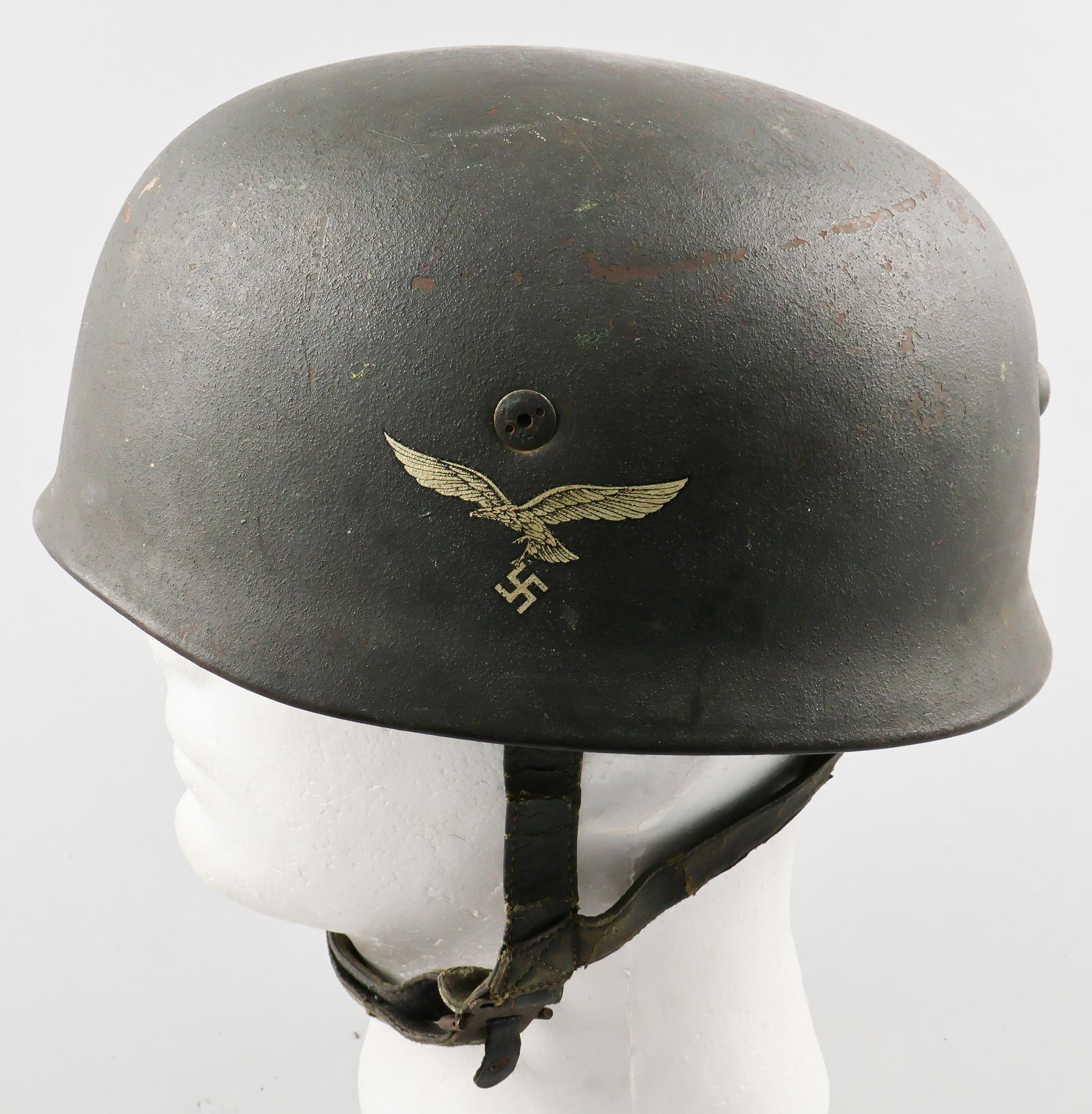 LUFTWAFFE M38 FALLSCHIRMJAGER HELMET: Mid-war Luftwaffe M38 ‘Fallschirmjager’ (Paratrooper) helmet. Shell is finished in field grey textured paint scheme, and looks to be a repaint from the helmet's original format. The liner