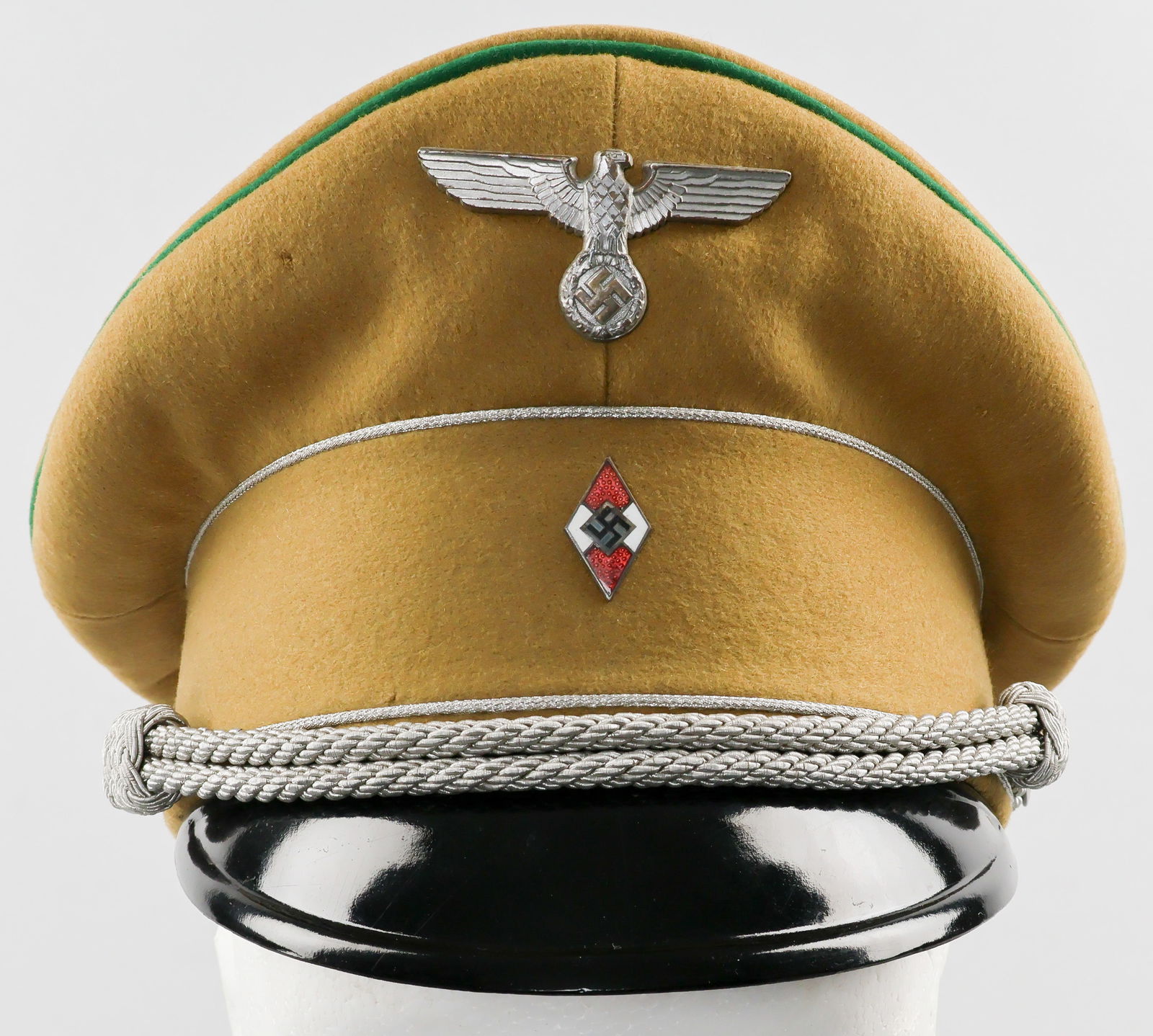 HITLER YOUTH LEADER VISOR CAP: Rare Hitler Youth Leader Visor Cap. Light brown wool body and sideband with silver wire piping at top and bottom of sideband, the ends perfectly joined. The top of the cap is piped in forest green wit