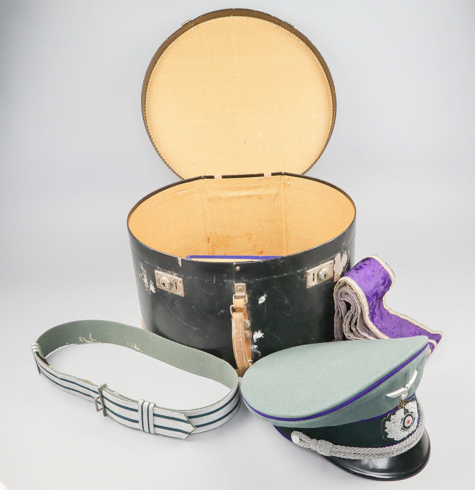 GERMAN CHAPLAIN'S VISOR CAP, STOLE, BELT AND CASE: An excessively rare German army chaplain's grouping including the chaplain's visor cap, religious stole, officer's belt, and carrying case. The visor cap is very special. It is constructed of feldgrau