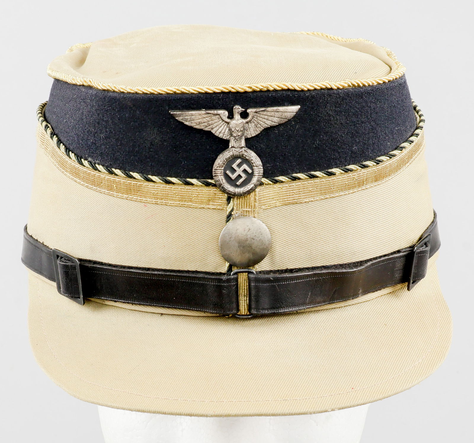 SA-GRUPPE BERLIN-BRANDENBURG STADARTENFUHRER’S SERVICE CAP: A very rare Sturmabteilung ‘coffee-can’-style cap or kepi with light khaki cotton drill crown, sides, and bill, with a black wool top beneath the crown, indicative of SA-Gruppe