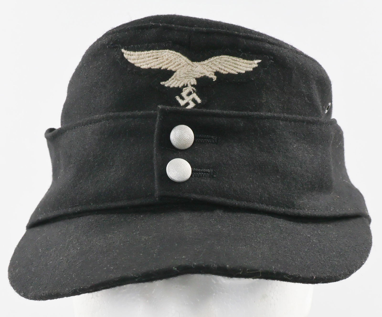 HERMANN GORING DIVISION E/M M-43 FIELD CAP: Scarce Hermann Goring Division Panzer enlisted man's M43 field cap, black wool construction with a black brim, embroidered wool eagle and cockade both stitched to the piece at the same time. Two
