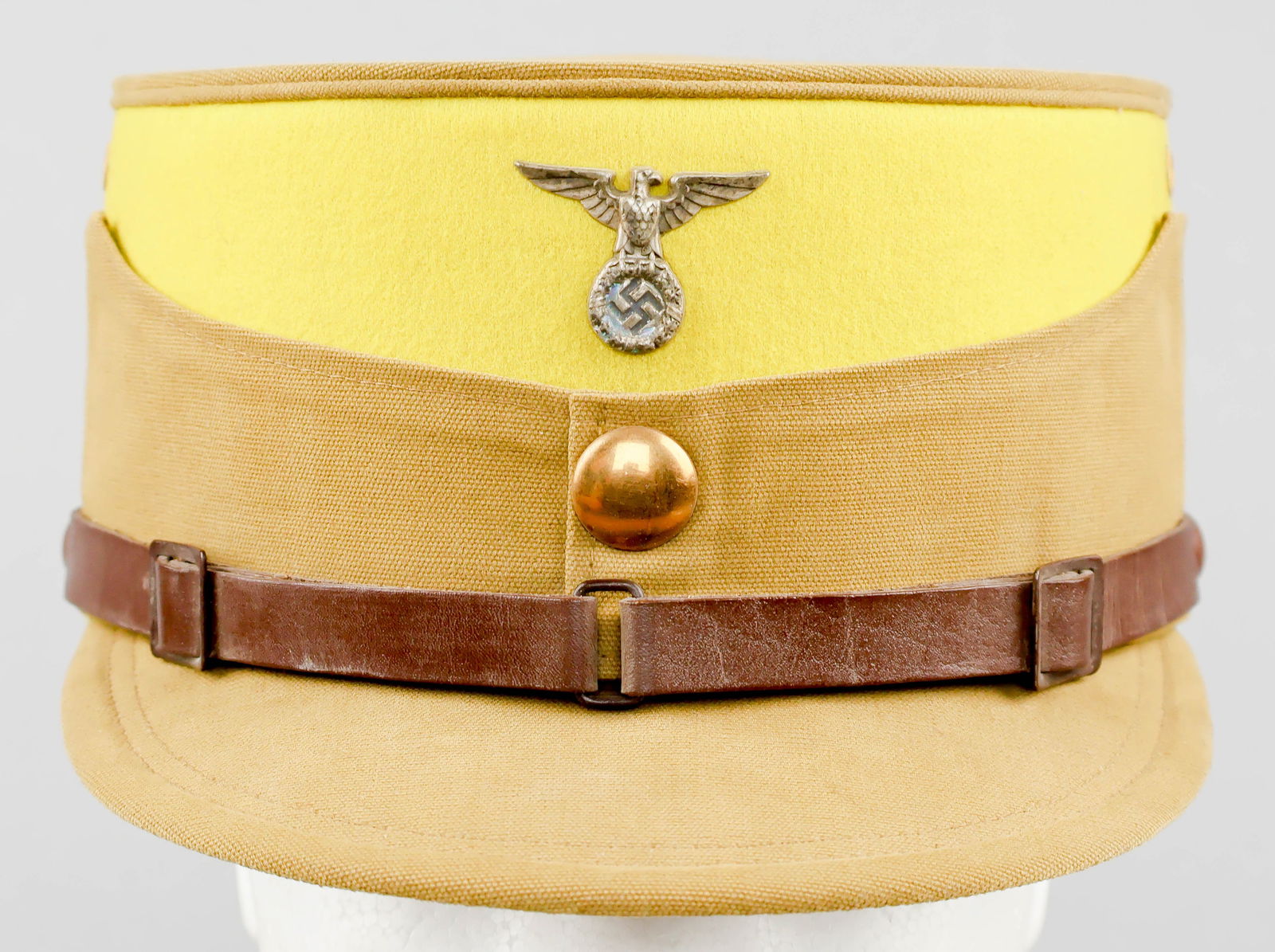 SA-GRUPPE FRANKEN SERVICE CAP: A very rare Sturmabteilung ‘coffee-can’-style cap or kepi with brown cotton crown, sides, and bill, with a sulfur yellow wool top beneath the crown, indicative of SA-Gruppe Franken,