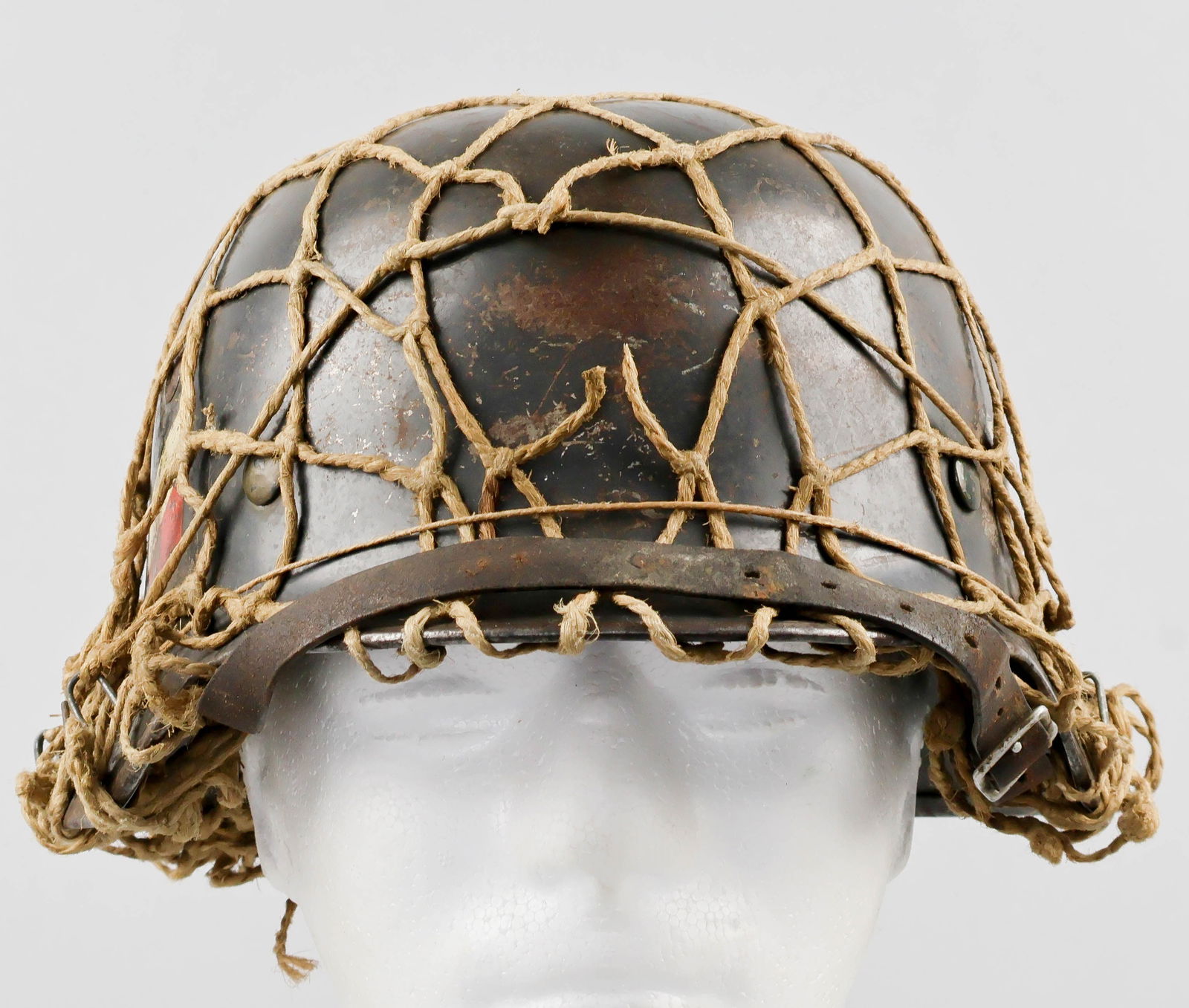 LUFTWAFFE DOUBLE-DECAL M35 HELMET: A fine example of a German M35 combat helmet, featuring a Luftwaffe eagle decal on the left-hand side, with a national tricolor decal on the right. The exterior and the interior skirt of the retains
