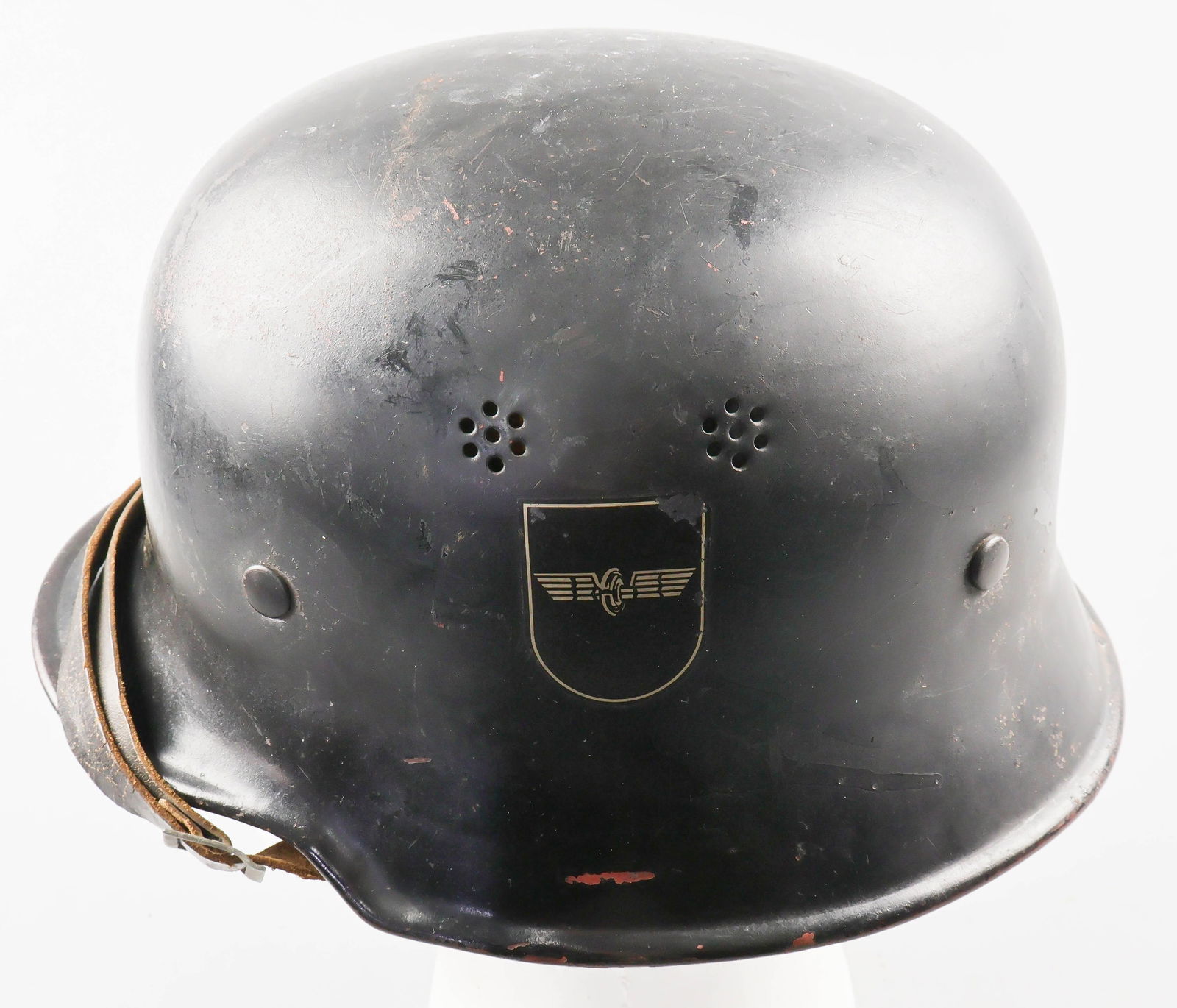 REICHSBAHN POLICE HELMET: German Reichsbahn Police M1942 steel helmet, bears a Reichsbahn decal applied to the left side, a national colors decal to the right, both largely intact. The black paint on the helmet is also very