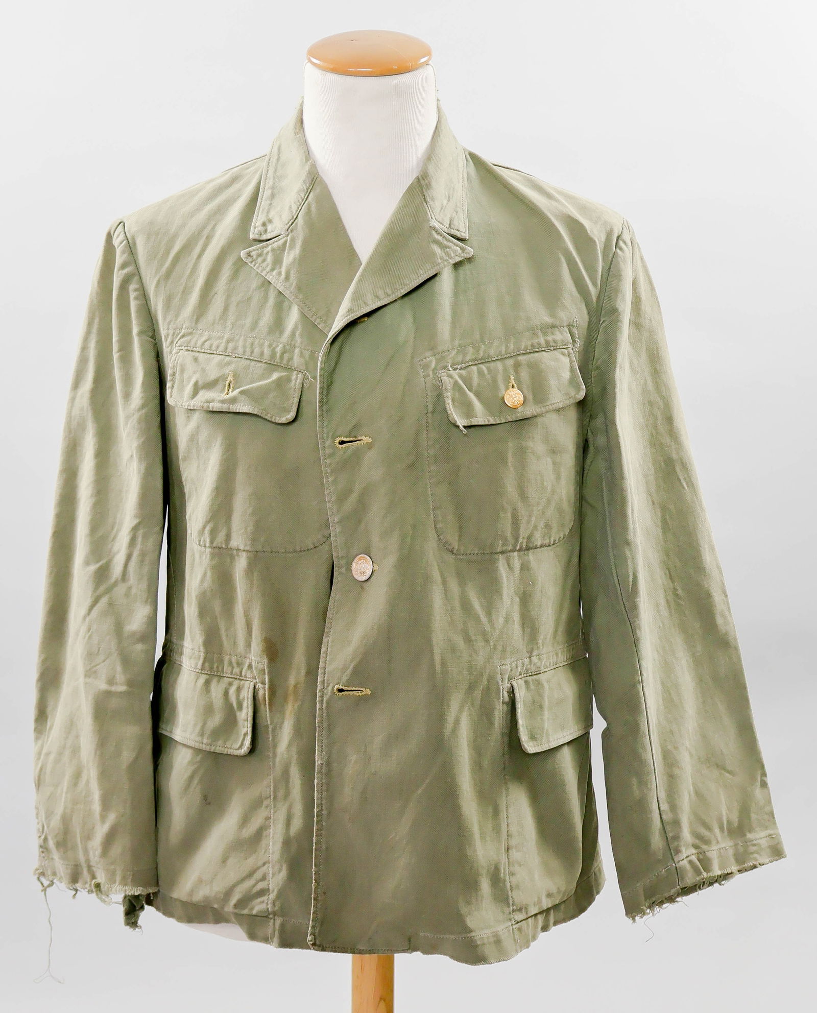 IMPERIAL JAPANESE NAVY BATTLESHIP YAMATO OFFICER’S TUNIC: A very rare, late war Imperial Japanese Navy petty officer’s or officer’s work uniform tunic, constructed of olive-green cotton twill with an open collar and flap-covered patch pockets on