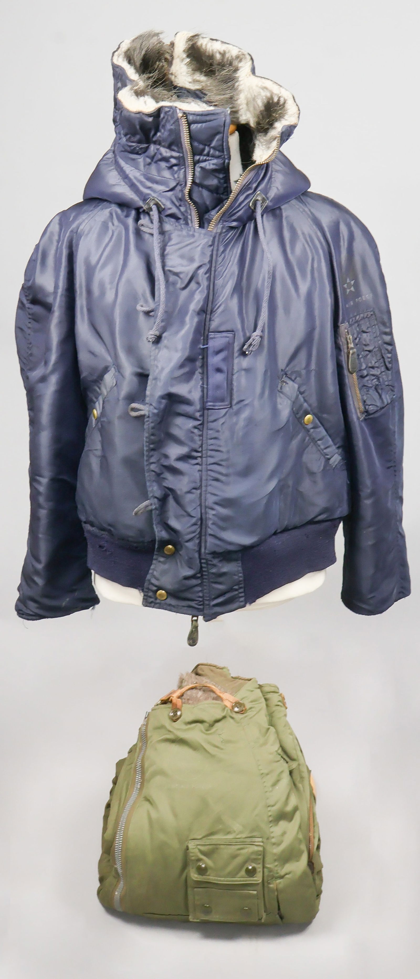 U.S. BOMBER JACKET AND COVERALLS: A uniform worn by a World War II bomber crewman comprising of a blue fur-lined jacket and a pair of green fur-lined coveralls. Fine.