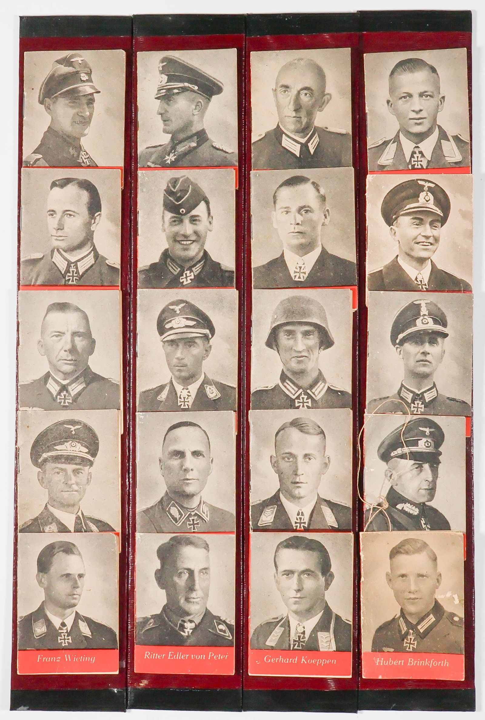 IRON CROSS WINNERS MINIATURE BOOKS (20): A set of miniature collector’s books which each honor an Iron Cross recipient. The books, 2.75 x 2 in. and string bound, feature the soldier’s image on the cover, with biographical