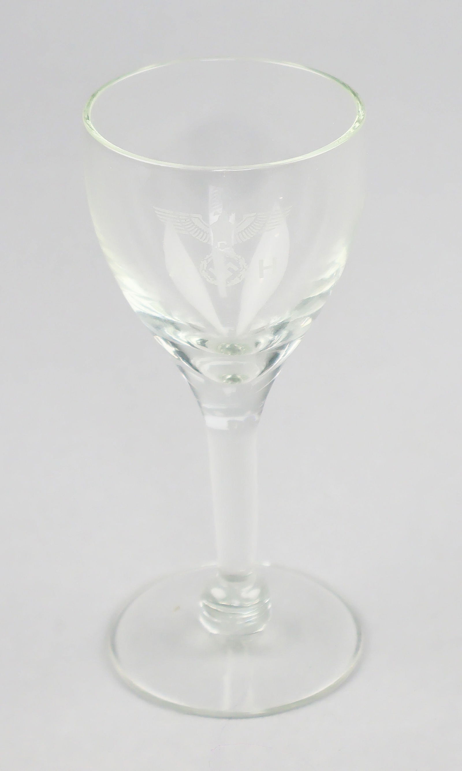 ADOLF HITLER SCHNAPPS GLASS: A great World War II relic, a small schnapps glass once owned by Adolf Hitler, 5 x 2.5 in. dia., bearing Hitler's seal - a national eagle surrounded by the engraved initials 'A H' - to one side, in a